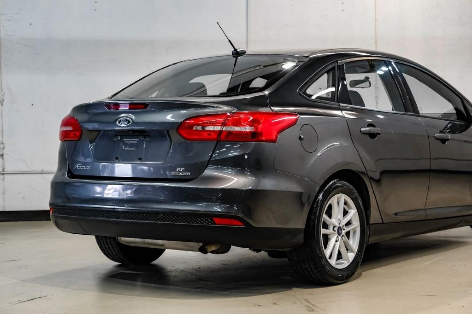 2016 Magnetic /Black Ford Focus SE (1FADP3F22GL) with an 2.0L 4-Cylinder DGI Flex Fuel DOHC engine, Automatic transmission, located at 15300 Midway Rd., Addison, TX, 75001, (972) 702-0011, 32.958321, -96.838074- Photo#12