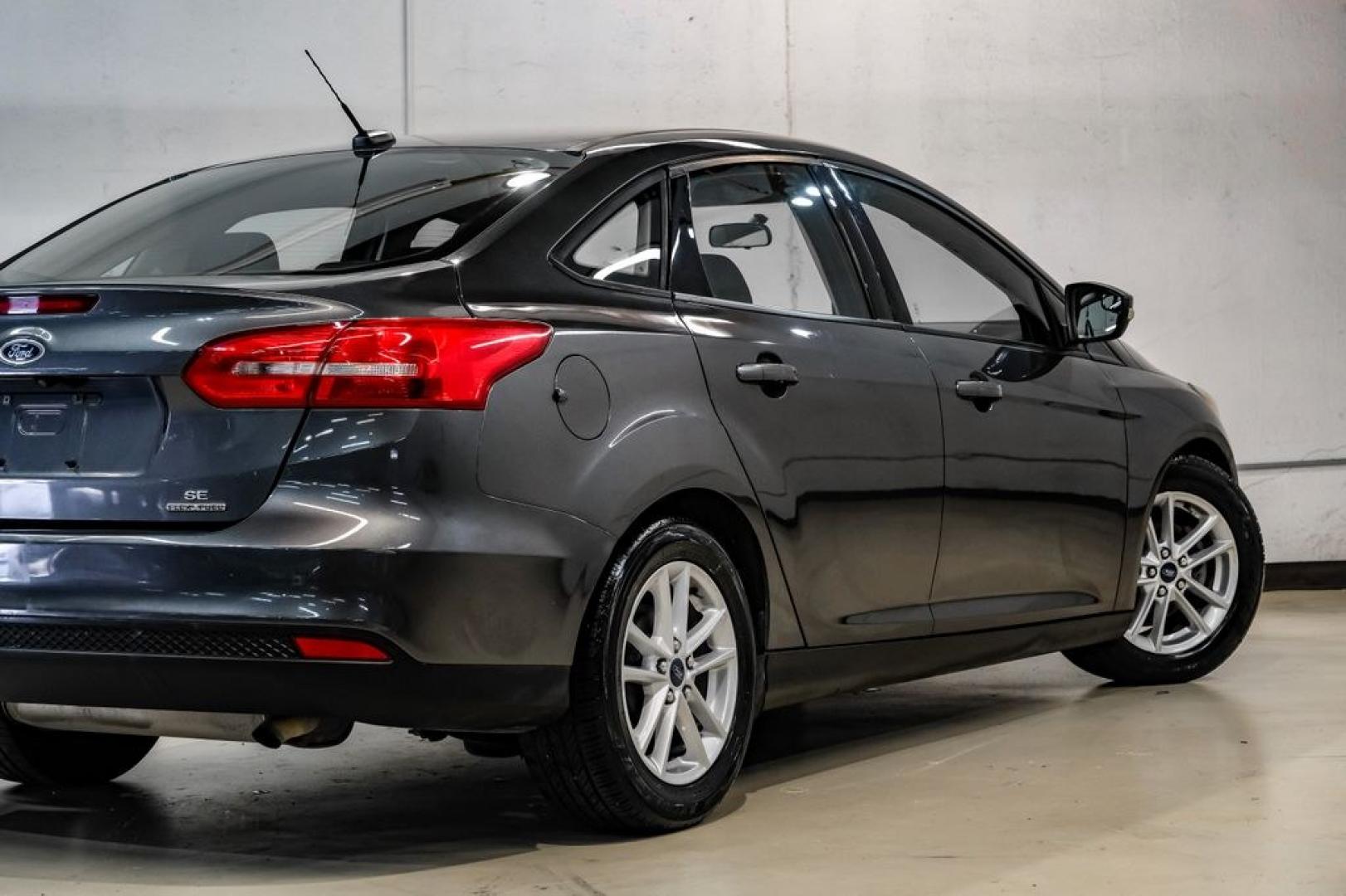 2016 Magnetic /Black Ford Focus SE (1FADP3F22GL) with an 2.0L 4-Cylinder DGI Flex Fuel DOHC engine, Automatic transmission, located at 15300 Midway Rd., Addison, TX, 75001, (972) 702-0011, 32.958321, -96.838074- Photo#13