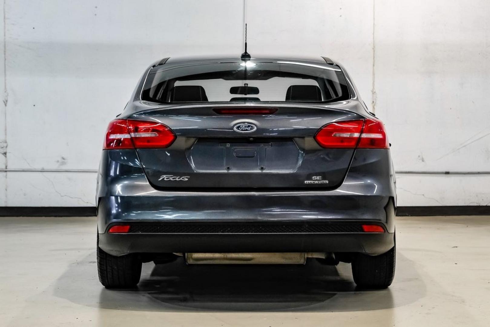 2016 Magnetic /Black Ford Focus SE (1FADP3F22GL) with an 2.0L 4-Cylinder DGI Flex Fuel DOHC engine, Automatic transmission, located at 15300 Midway Rd., Addison, TX, 75001, (972) 702-0011, 32.958321, -96.838074- Photo#14