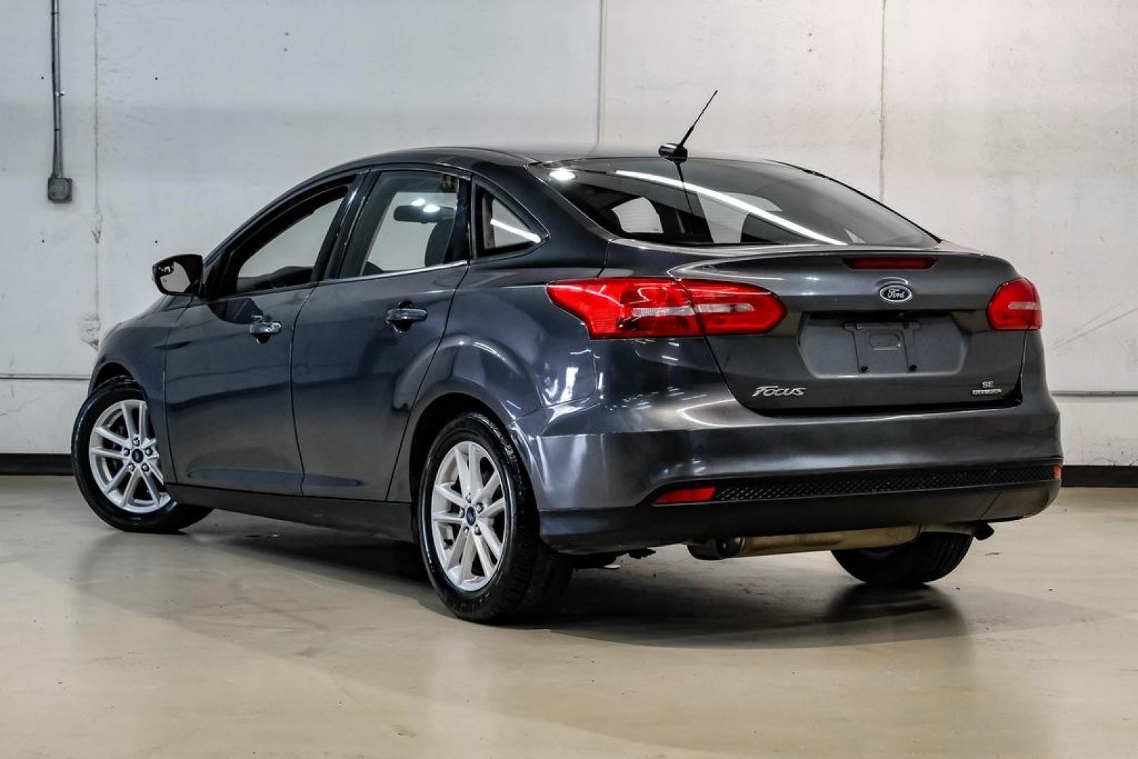 2016 Magnetic /Black Ford Focus SE (1FADP3F22GL) with an 2.0L 4-Cylinder DGI Flex Fuel DOHC engine, Automatic transmission, located at 15300 Midway Rd., Addison, TX, 75001, (972) 702-0011, 32.958321, -96.838074- Photo#15
