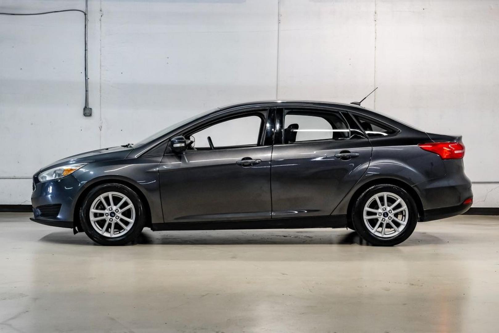 2016 Magnetic /Black Ford Focus SE (1FADP3F22GL) with an 2.0L 4-Cylinder DGI Flex Fuel DOHC engine, Automatic transmission, located at 15300 Midway Rd., Addison, TX, 75001, (972) 702-0011, 32.958321, -96.838074- Photo#16