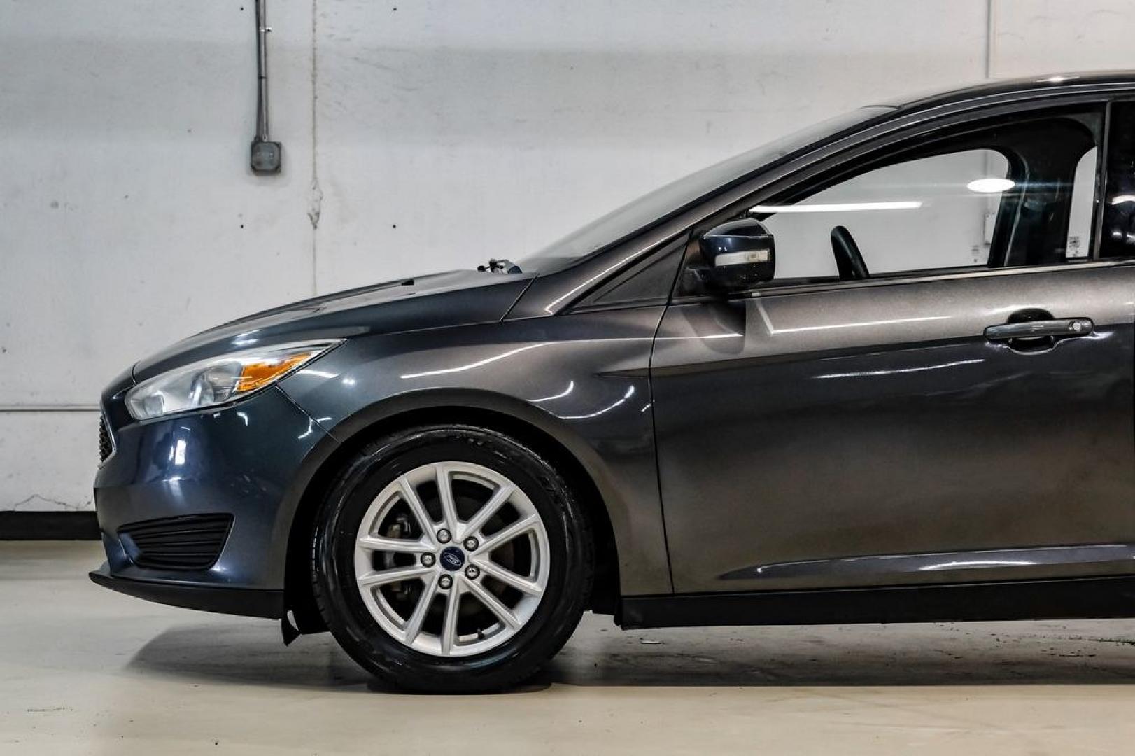2016 Magnetic /Black Ford Focus SE (1FADP3F22GL) with an 2.0L 4-Cylinder DGI Flex Fuel DOHC engine, Automatic transmission, located at 15300 Midway Rd., Addison, TX, 75001, (972) 702-0011, 32.958321, -96.838074- Photo#17