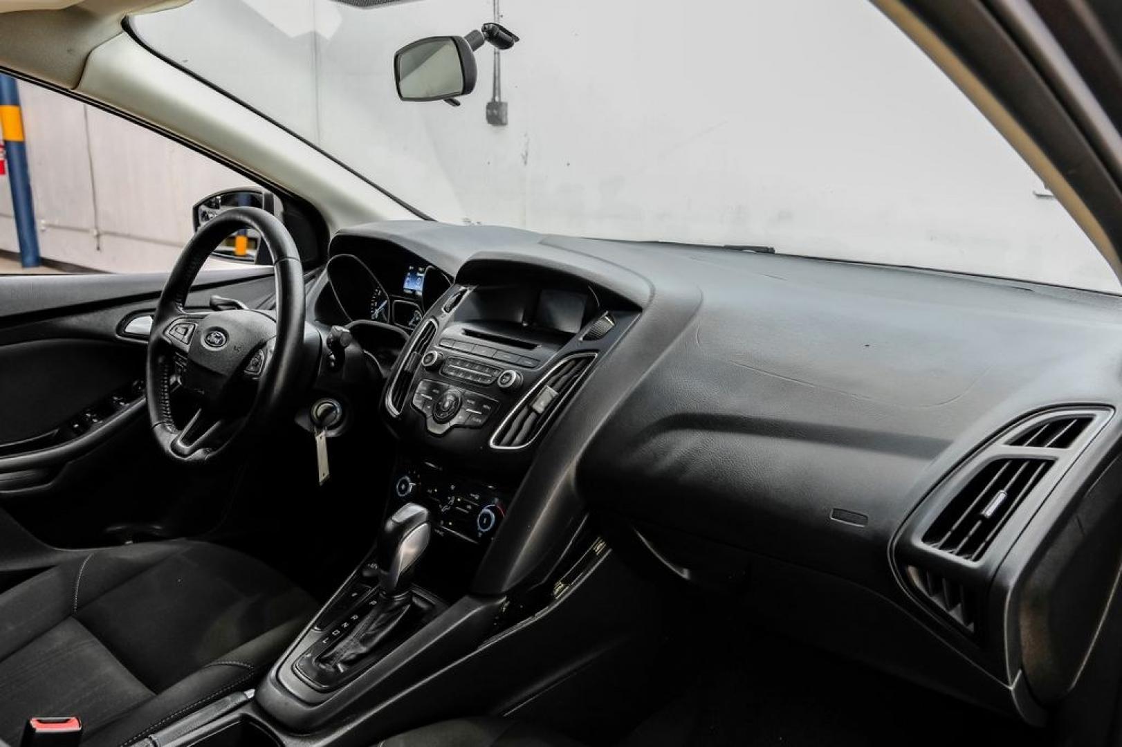 2016 Magnetic /Black Ford Focus SE (1FADP3F22GL) with an 2.0L 4-Cylinder DGI Flex Fuel DOHC engine, Automatic transmission, located at 15300 Midway Rd., Addison, TX, 75001, (972) 702-0011, 32.958321, -96.838074- Photo#19