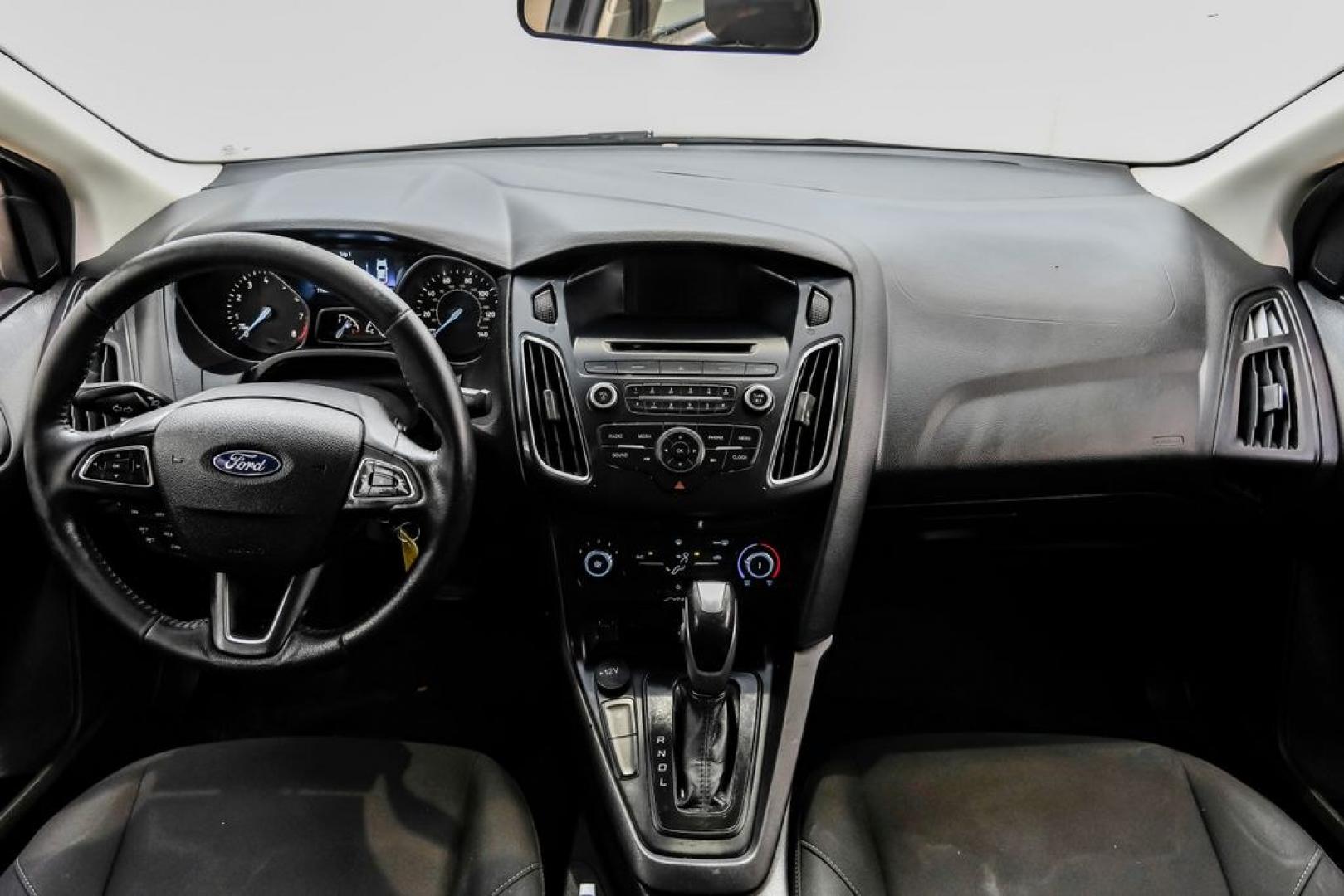 2016 Magnetic /Black Ford Focus SE (1FADP3F22GL) with an 2.0L 4-Cylinder DGI Flex Fuel DOHC engine, Automatic transmission, located at 15300 Midway Rd., Addison, TX, 75001, (972) 702-0011, 32.958321, -96.838074- Photo#20