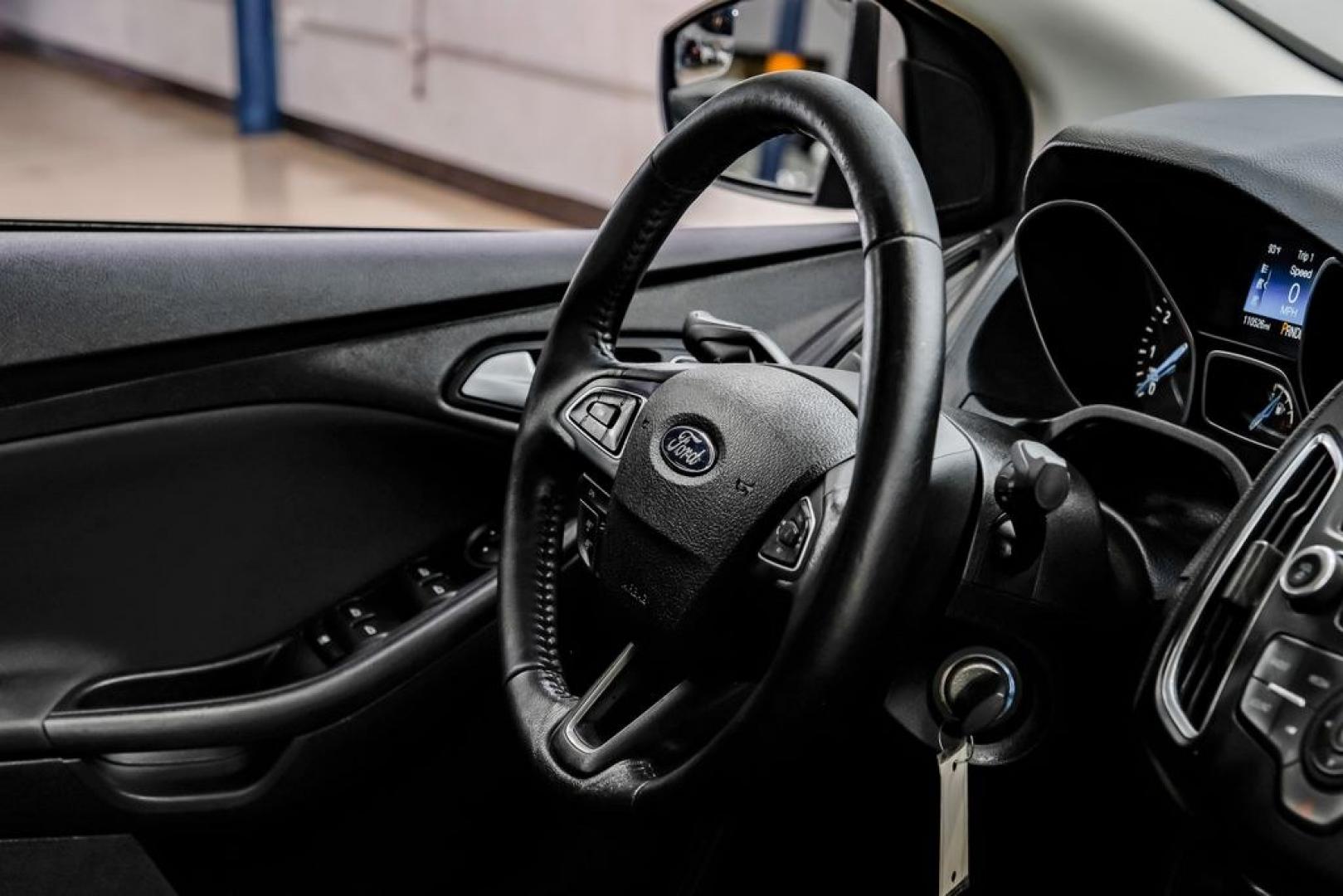 2016 Magnetic /Black Ford Focus SE (1FADP3F22GL) with an 2.0L 4-Cylinder DGI Flex Fuel DOHC engine, Automatic transmission, located at 15300 Midway Rd., Addison, TX, 75001, (972) 702-0011, 32.958321, -96.838074- Photo#21