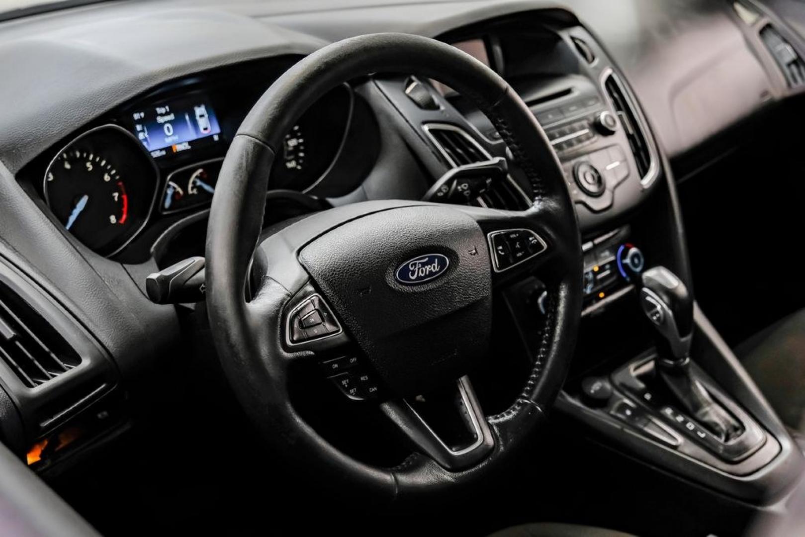 2016 Magnetic /Black Ford Focus SE (1FADP3F22GL) with an 2.0L 4-Cylinder DGI Flex Fuel DOHC engine, Automatic transmission, located at 15300 Midway Rd., Addison, TX, 75001, (972) 702-0011, 32.958321, -96.838074- Photo#22