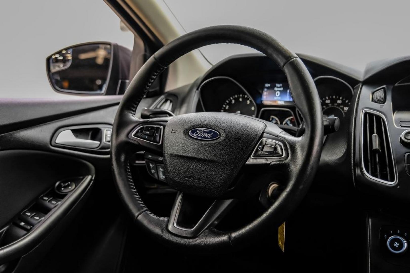 2016 Magnetic /Black Ford Focus SE (1FADP3F22GL) with an 2.0L 4-Cylinder DGI Flex Fuel DOHC engine, Automatic transmission, located at 15300 Midway Rd., Addison, TX, 75001, (972) 702-0011, 32.958321, -96.838074- Photo#23