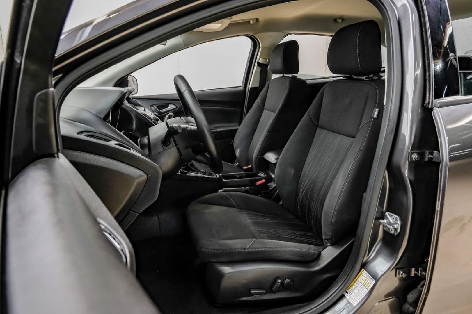 2016 Magnetic /Black Ford Focus SE (1FADP3F22GL) with an 2.0L 4-Cylinder DGI Flex Fuel DOHC engine, Automatic transmission, located at 15300 Midway Rd., Addison, TX, 75001, (972) 702-0011, 32.958321, -96.838074- Photo#41