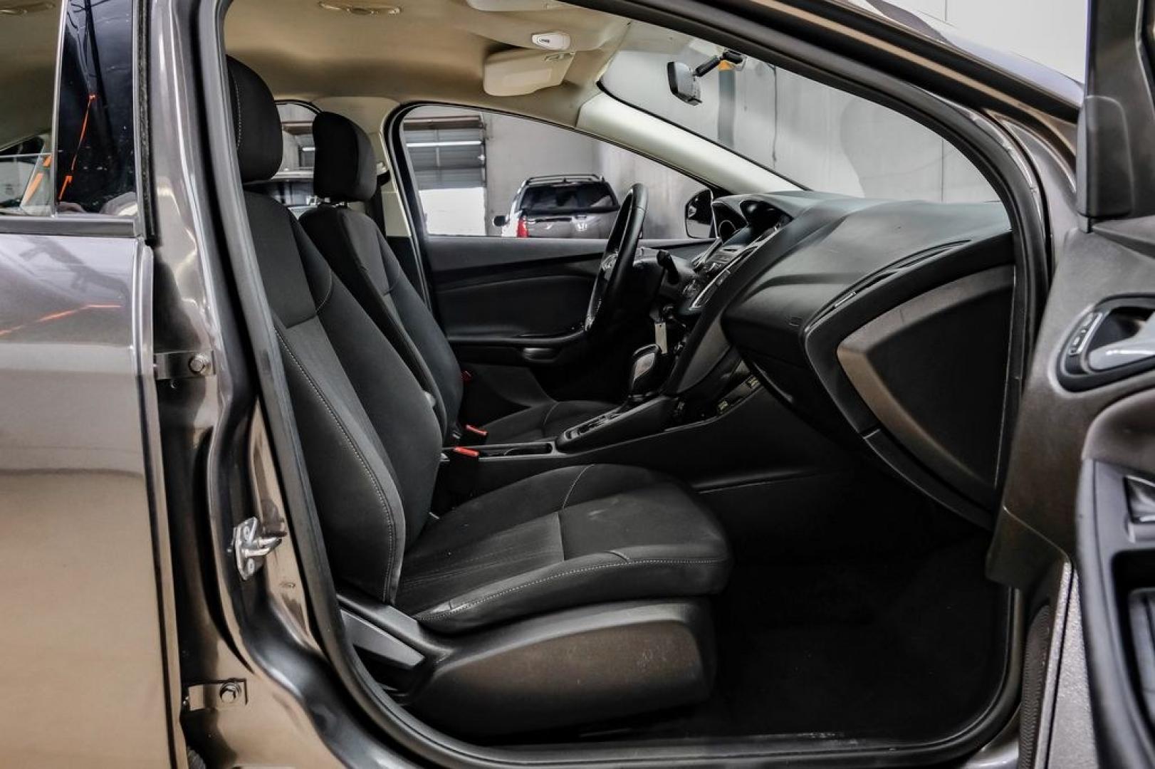 2016 Magnetic /Black Ford Focus SE (1FADP3F22GL) with an 2.0L 4-Cylinder DGI Flex Fuel DOHC engine, Automatic transmission, located at 15300 Midway Rd., Addison, TX, 75001, (972) 702-0011, 32.958321, -96.838074- Photo#43