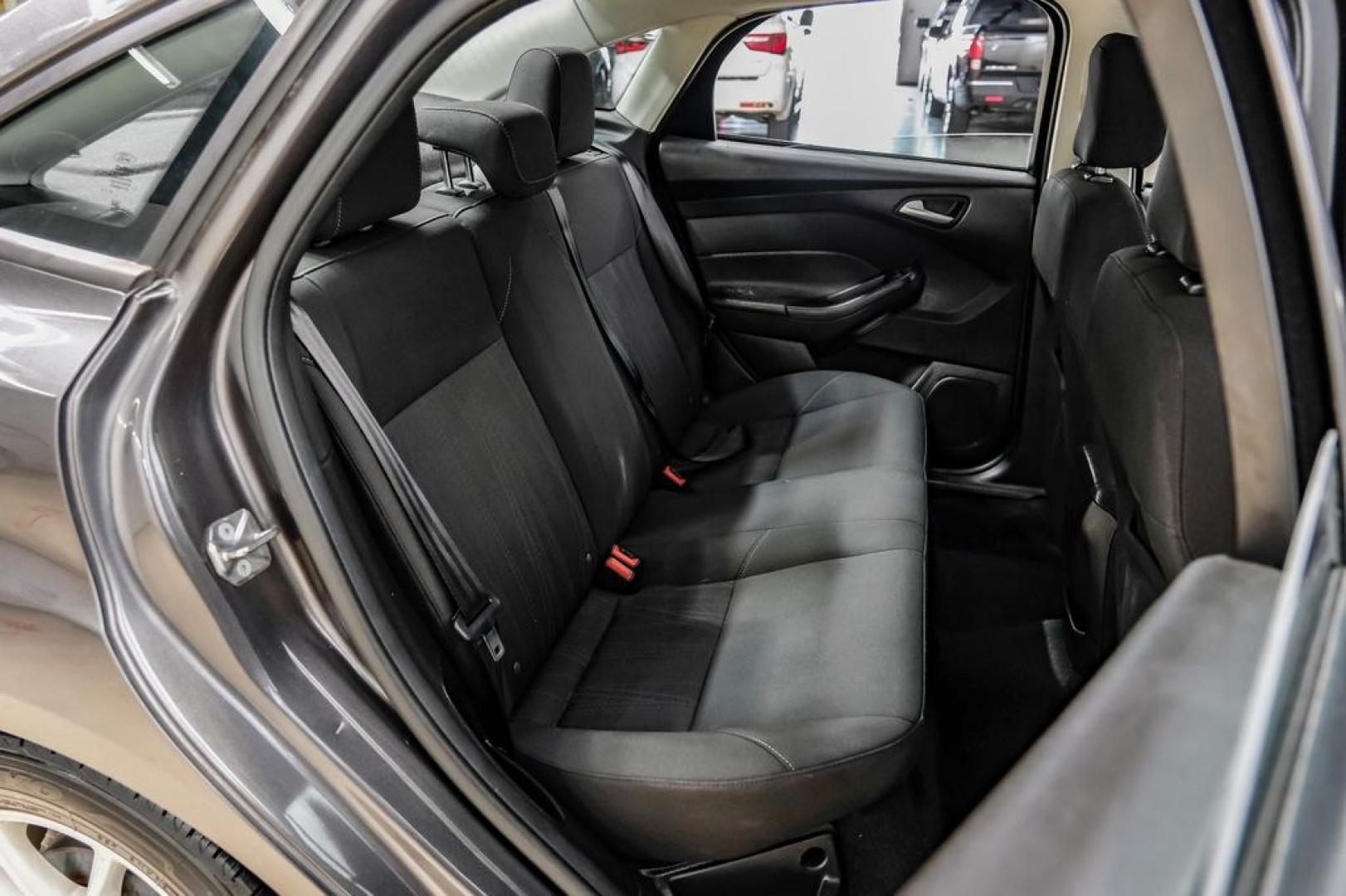 2016 Magnetic /Black Ford Focus SE (1FADP3F22GL) with an 2.0L 4-Cylinder DGI Flex Fuel DOHC engine, Automatic transmission, located at 15300 Midway Rd., Addison, TX, 75001, (972) 702-0011, 32.958321, -96.838074- Photo#45