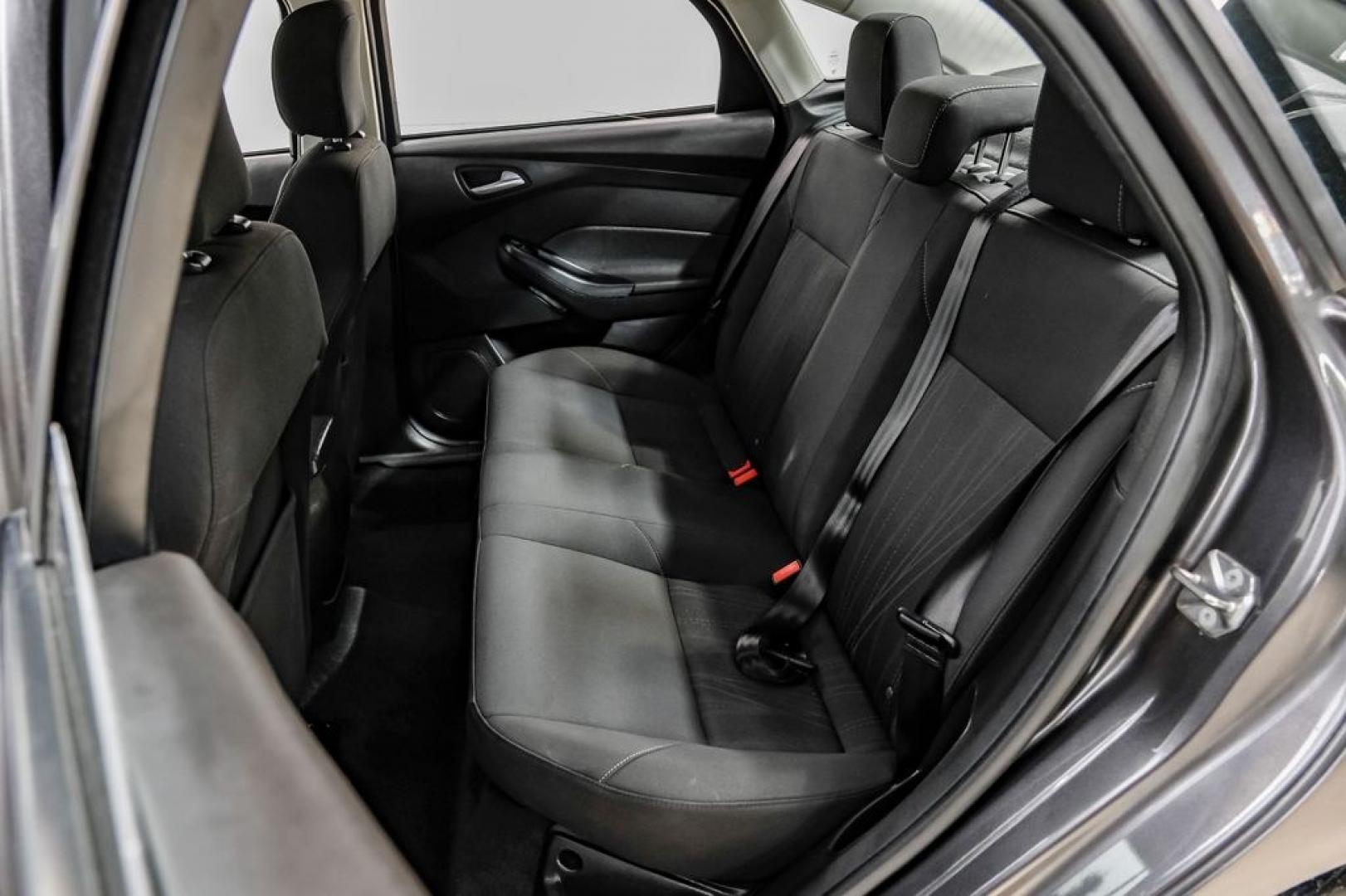 2016 Magnetic /Black Ford Focus SE (1FADP3F22GL) with an 2.0L 4-Cylinder DGI Flex Fuel DOHC engine, Automatic transmission, located at 15300 Midway Rd., Addison, TX, 75001, (972) 702-0011, 32.958321, -96.838074- Photo#48