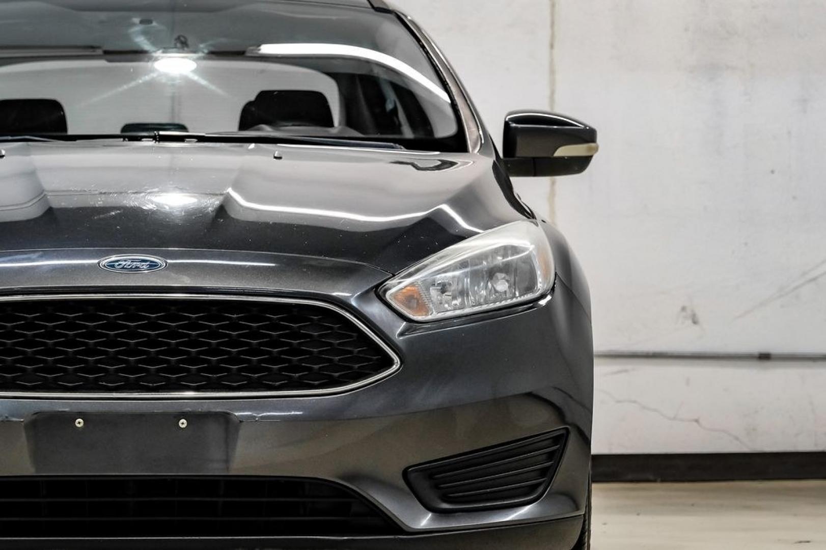 2016 Magnetic /Black Ford Focus SE (1FADP3F22GL) with an 2.0L 4-Cylinder DGI Flex Fuel DOHC engine, Automatic transmission, located at 15300 Midway Rd., Addison, TX, 75001, (972) 702-0011, 32.958321, -96.838074- Photo#57