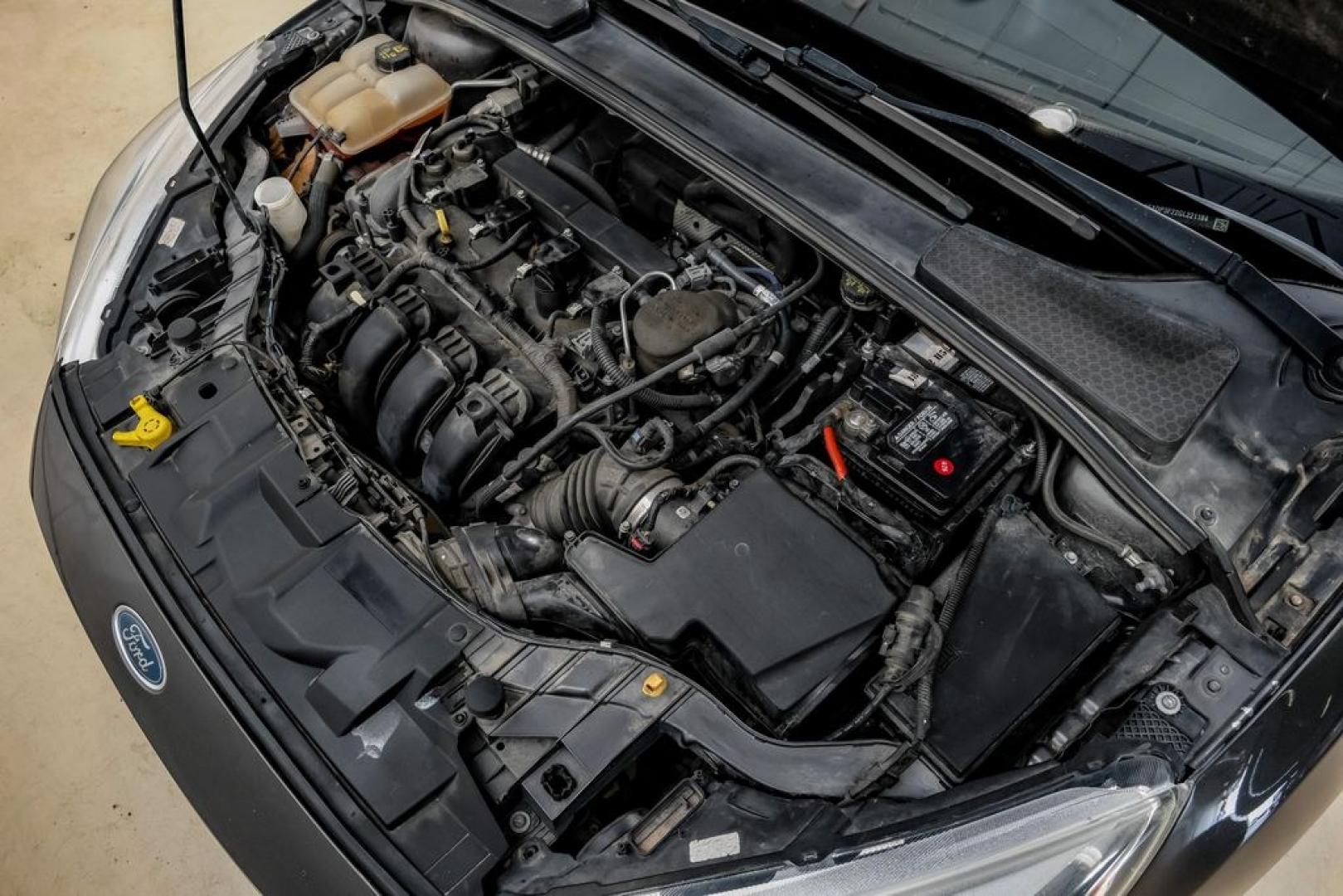 2016 Magnetic /Black Ford Focus SE (1FADP3F22GL) with an 2.0L 4-Cylinder DGI Flex Fuel DOHC engine, Automatic transmission, located at 15300 Midway Rd., Addison, TX, 75001, (972) 702-0011, 32.958321, -96.838074- Photo#60