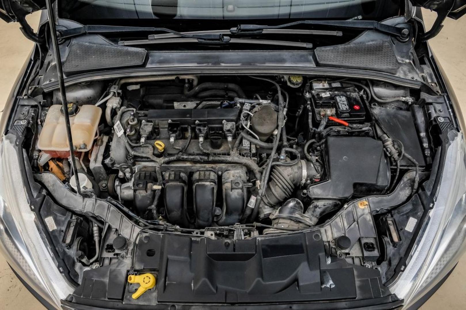 2016 Magnetic /Black Ford Focus SE (1FADP3F22GL) with an 2.0L 4-Cylinder DGI Flex Fuel DOHC engine, Automatic transmission, located at 15300 Midway Rd., Addison, TX, 75001, (972) 702-0011, 32.958321, -96.838074- Photo#61