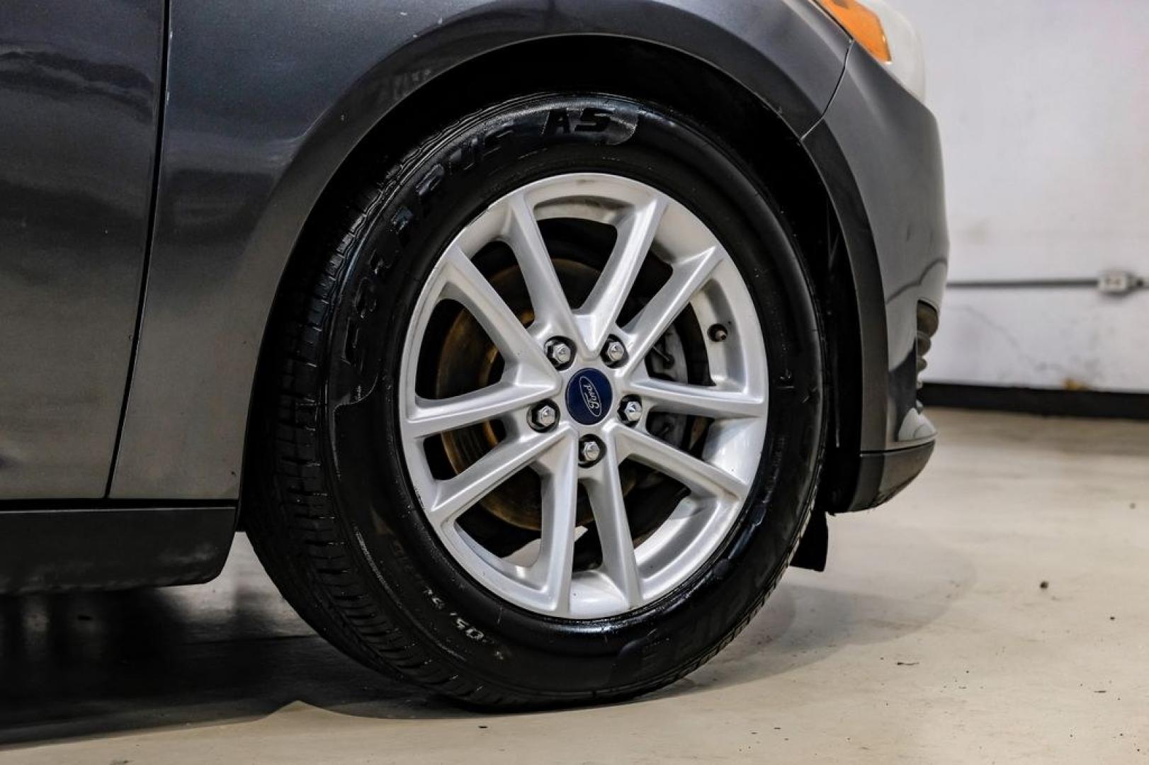 2016 Magnetic /Black Ford Focus SE (1FADP3F22GL) with an 2.0L 4-Cylinder DGI Flex Fuel DOHC engine, Automatic transmission, located at 15300 Midway Rd., Addison, TX, 75001, (972) 702-0011, 32.958321, -96.838074- Photo#66