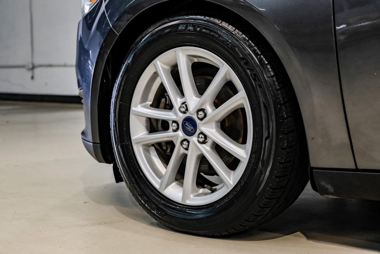 2016 Magnetic /Black Ford Focus SE (1FADP3F22GL) with an 2.0L 4-Cylinder DGI Flex Fuel DOHC engine, Automatic transmission, located at 15300 Midway Rd., Addison, TX, 75001, (972) 702-0011, 32.958321, -96.838074- Photo#67