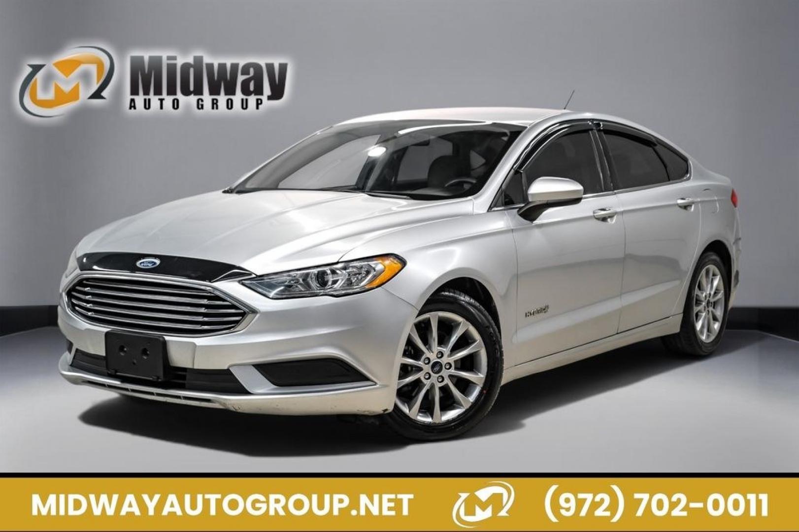 2017 Ingot Silver /Medium Light Stone Ford Fusion Hybrid SE (3FA6P0LU3HR) with an I4 Hybrid engine, CVT transmission, located at 15300 Midway Rd., Addison, TX, 75001, (972) 702-0011, 32.958321, -96.838074- Photo#0