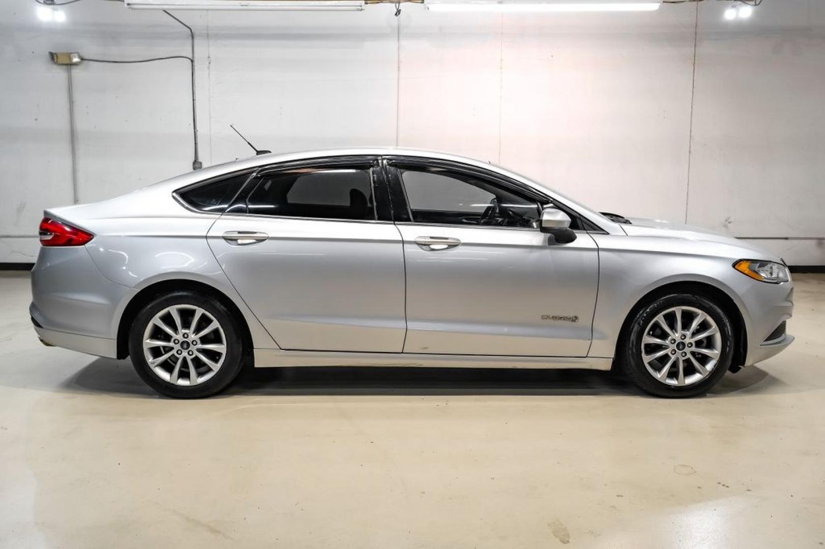 2017 Ingot Silver /Medium Light Stone Ford Fusion Hybrid SE (3FA6P0LU3HR) with an I4 Hybrid engine, CVT transmission, located at 15300 Midway Rd., Addison, TX, 75001, (972) 702-0011, 32.958321, -96.838074- Photo#5