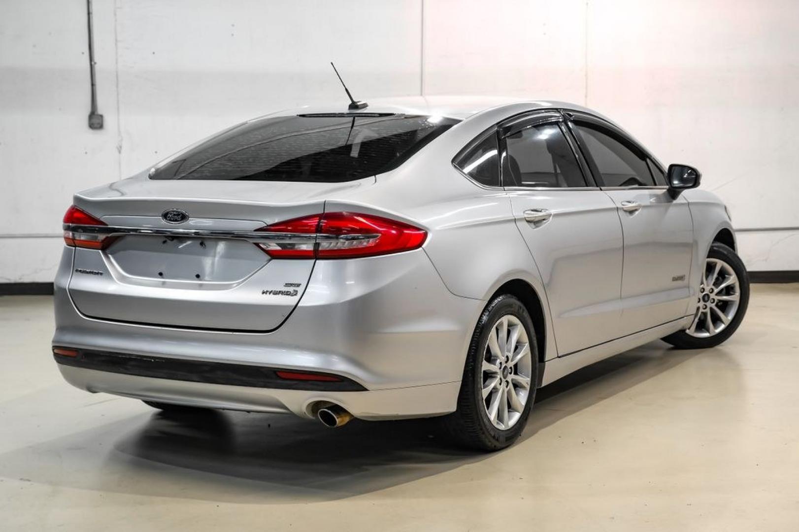 2017 Ingot Silver /Medium Light Stone Ford Fusion Hybrid SE (3FA6P0LU3HR) with an I4 Hybrid engine, CVT transmission, located at 15300 Midway Rd., Addison, TX, 75001, (972) 702-0011, 32.958321, -96.838074- Photo#6