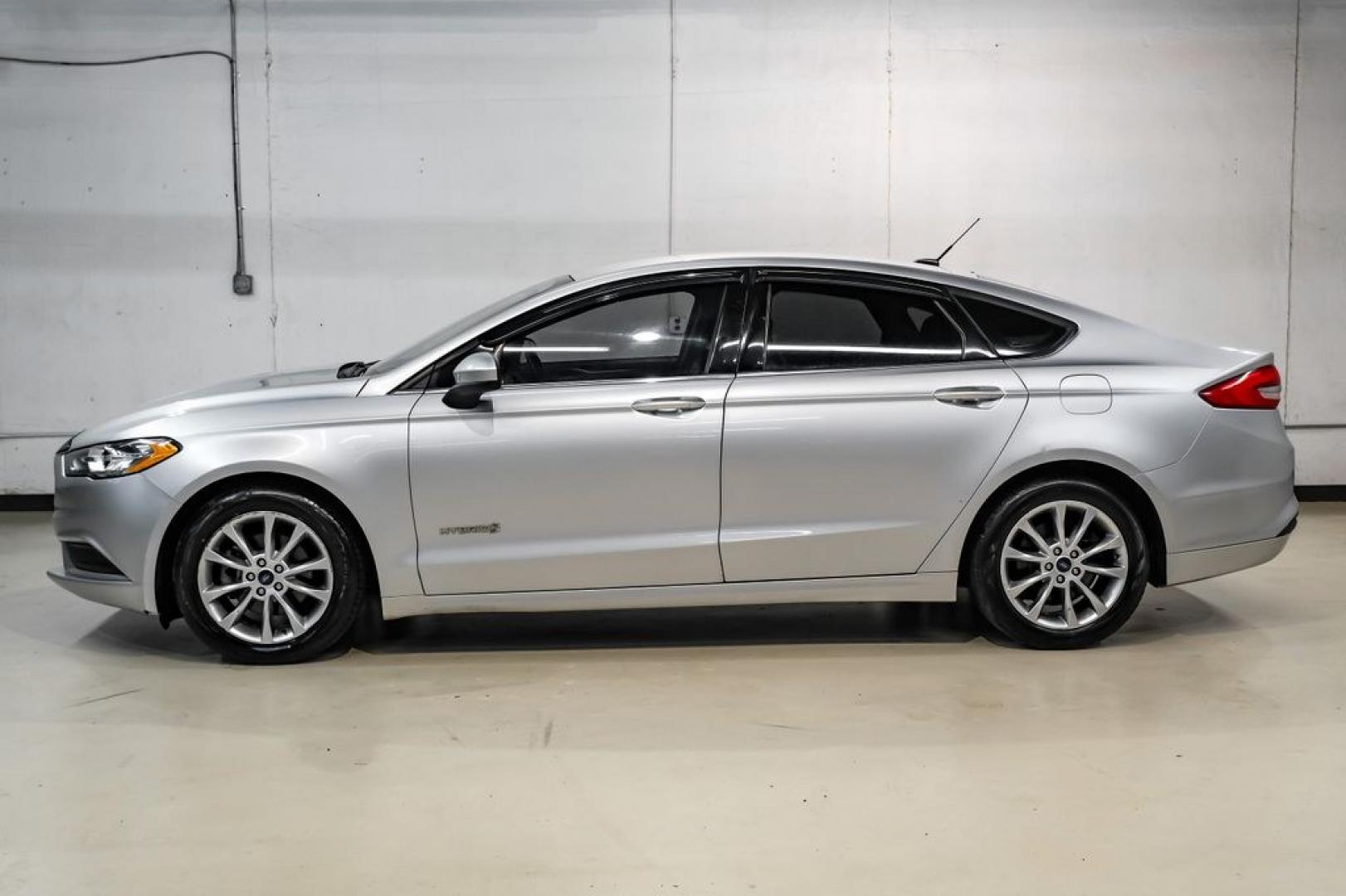 2017 Ingot Silver /Medium Light Stone Ford Fusion Hybrid SE (3FA6P0LU3HR) with an I4 Hybrid engine, CVT transmission, located at 15300 Midway Rd., Addison, TX, 75001, (972) 702-0011, 32.958321, -96.838074- Photo#9