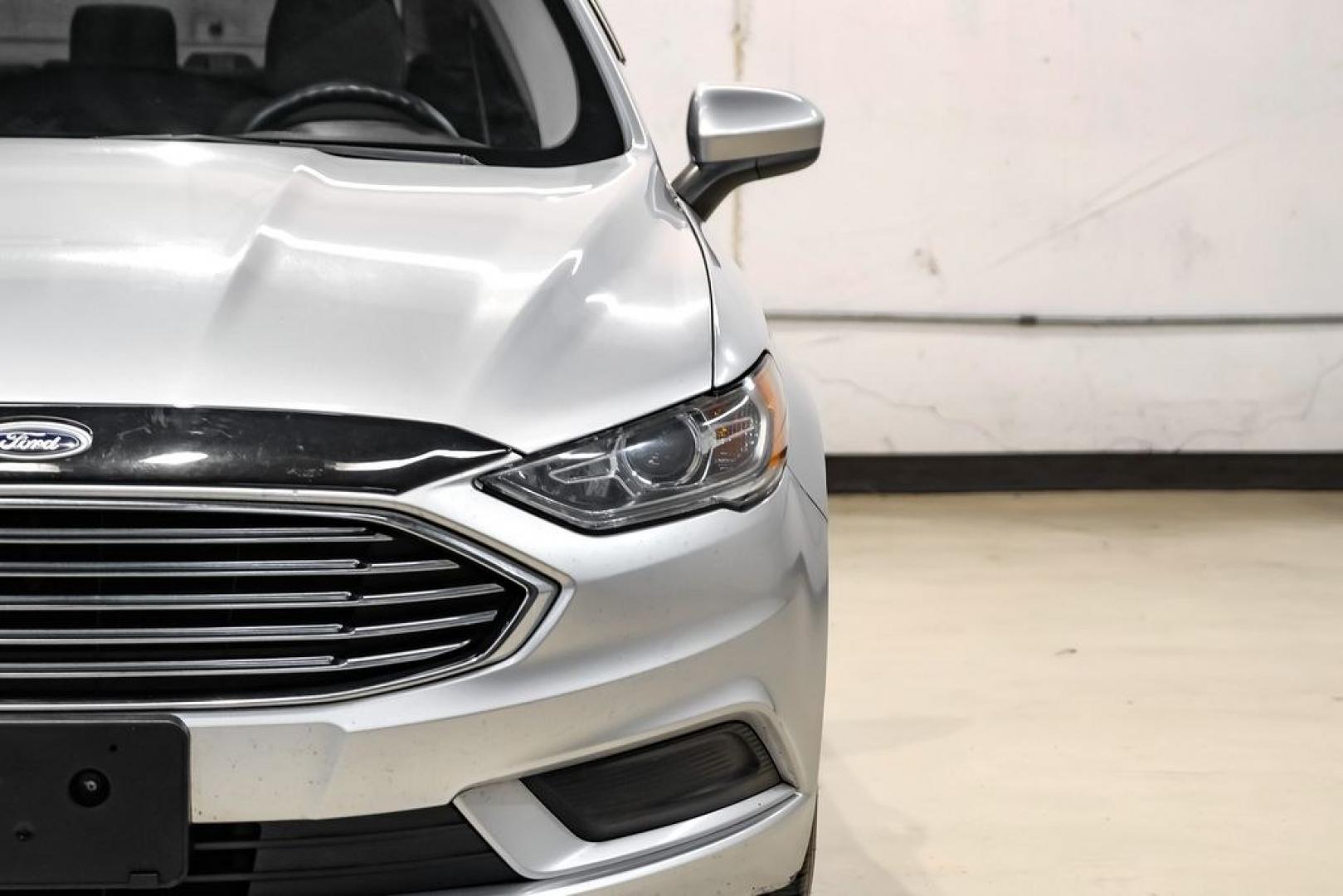 2017 Ingot Silver /Medium Light Stone Ford Fusion Hybrid SE (3FA6P0LU3HR) with an I4 Hybrid engine, CVT transmission, located at 15300 Midway Rd., Addison, TX, 75001, (972) 702-0011, 32.958321, -96.838074- Photo#43