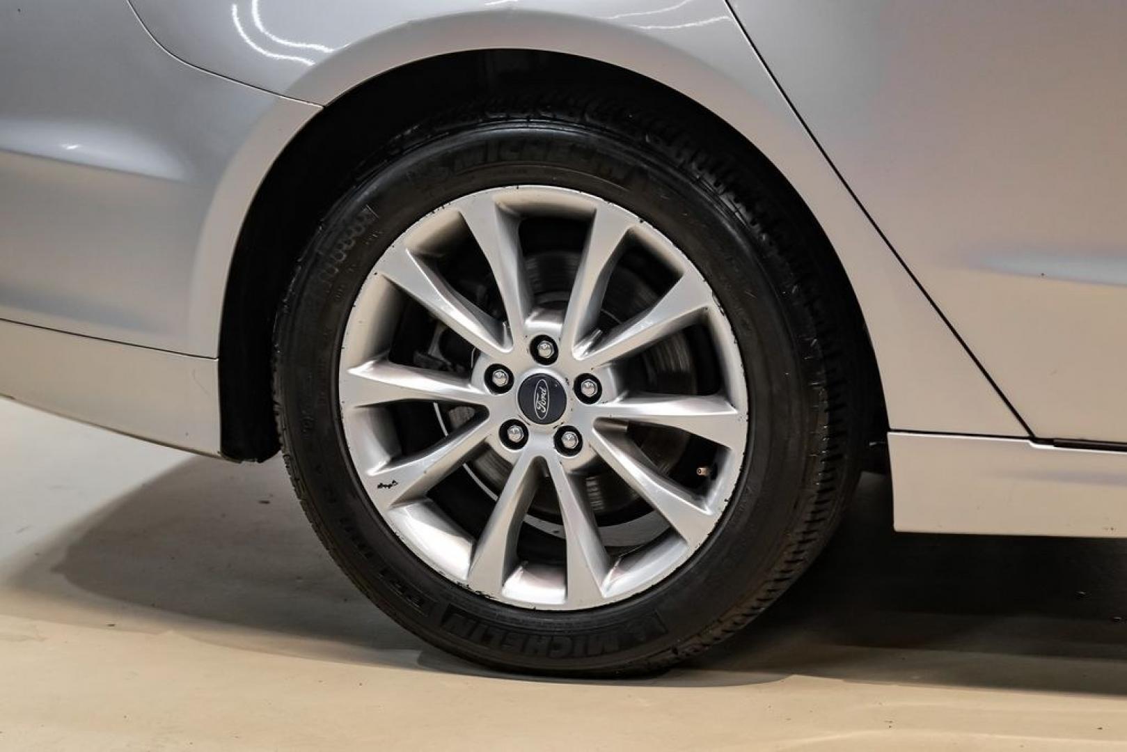 2017 Ingot Silver /Medium Light Stone Ford Fusion Hybrid SE (3FA6P0LU3HR) with an I4 Hybrid engine, CVT transmission, located at 15300 Midway Rd., Addison, TX, 75001, (972) 702-0011, 32.958321, -96.838074- Photo#50
