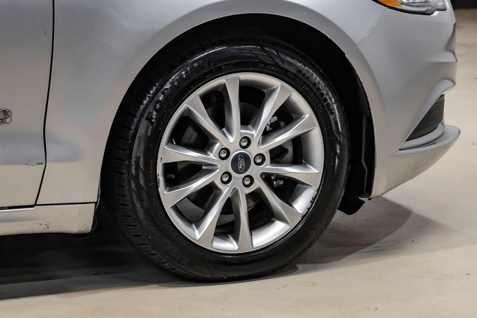 2017 Ingot Silver /Medium Light Stone Ford Fusion Hybrid SE (3FA6P0LU3HR) with an I4 Hybrid engine, CVT transmission, located at 15300 Midway Rd., Addison, TX, 75001, (972) 702-0011, 32.958321, -96.838074- Photo#51