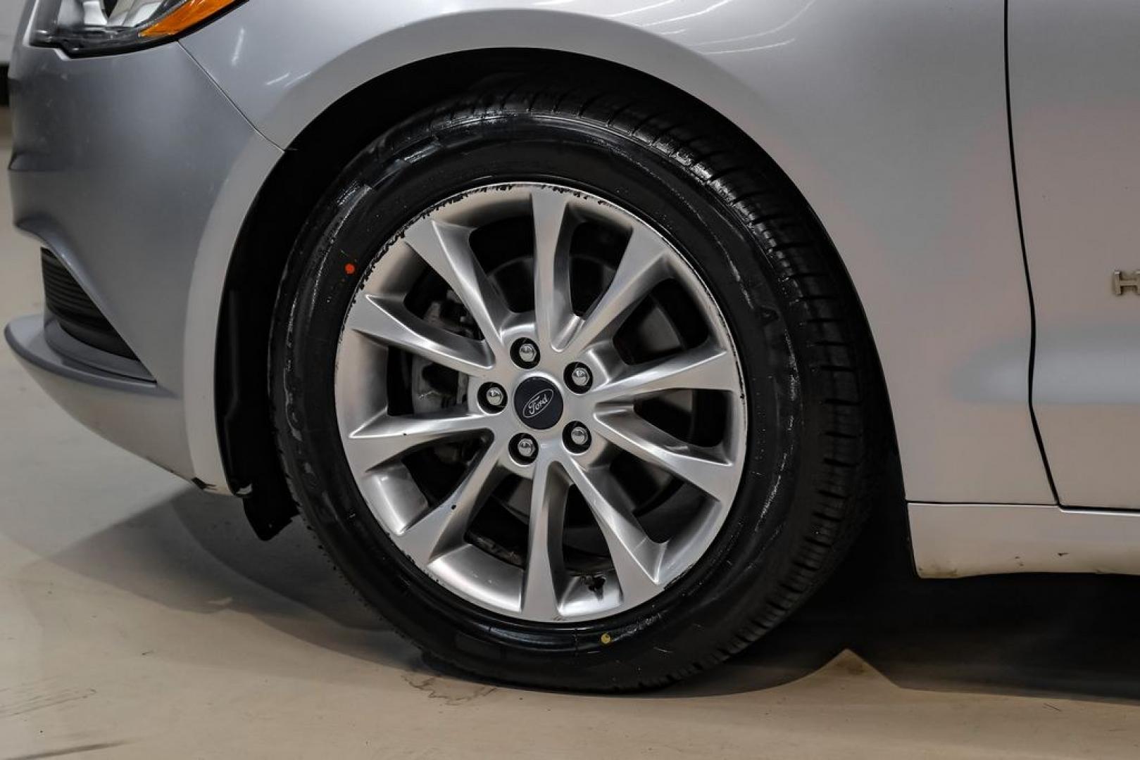2017 Ingot Silver /Medium Light Stone Ford Fusion Hybrid SE (3FA6P0LU3HR) with an I4 Hybrid engine, CVT transmission, located at 15300 Midway Rd., Addison, TX, 75001, (972) 702-0011, 32.958321, -96.838074- Photo#52