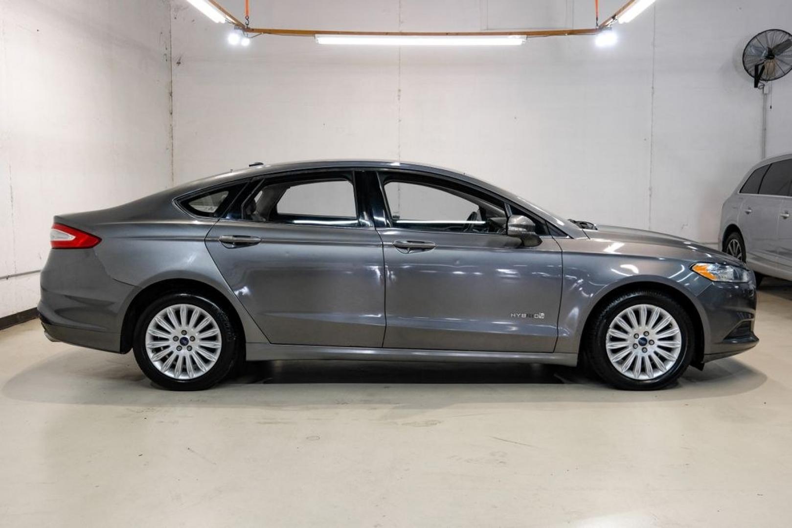 2014 Sterling Gray Metallic /Dune Ford Fusion Hybrid SE (3FA6P0LU0ER) with an 2.0L I4 Atkinson-Cycle Hybrid engine, CVT transmission, located at 15300 Midway Rd., Addison, TX, 75001, (972) 702-0011, 32.958321, -96.838074- Photo#6