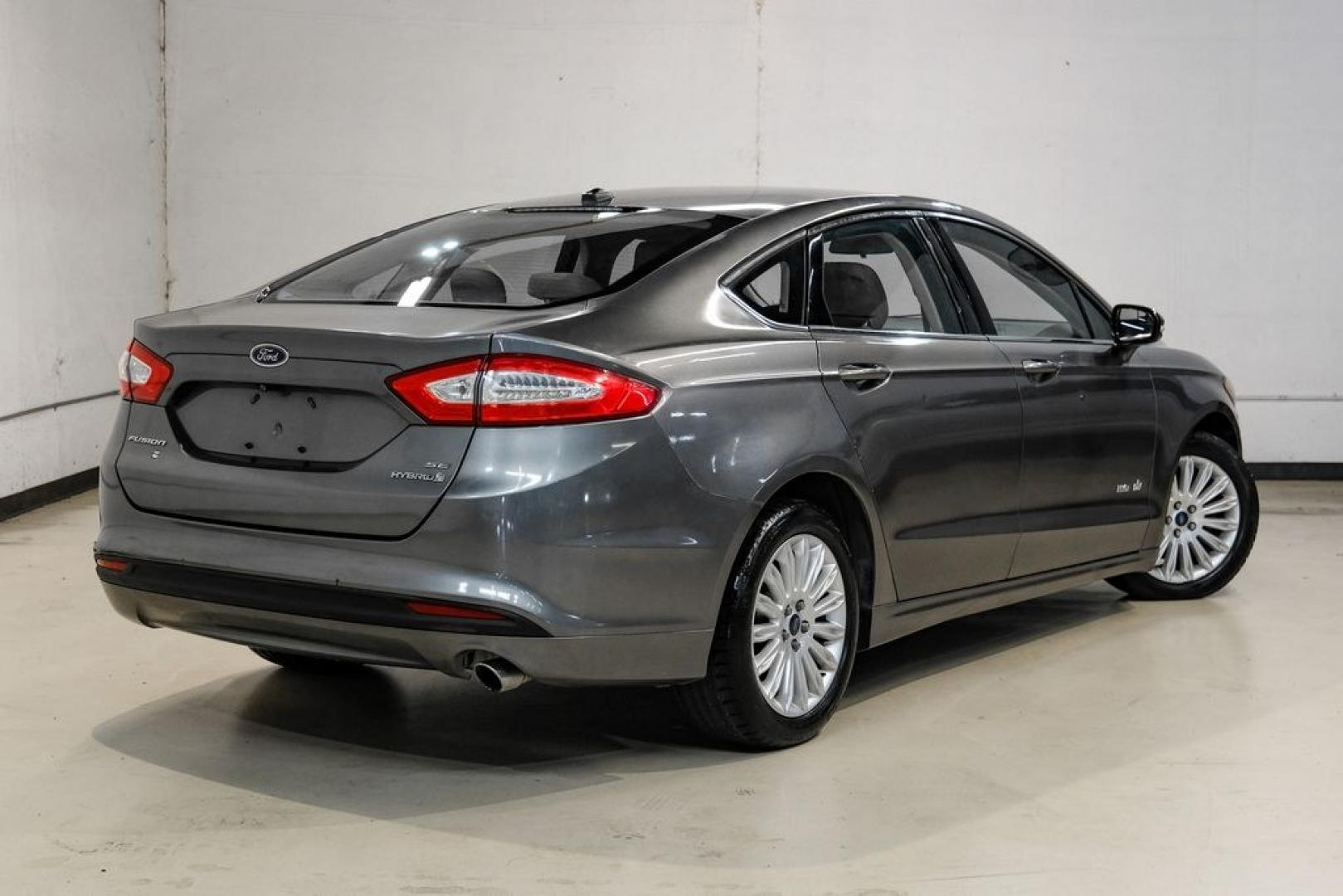 2014 Sterling Gray Metallic /Dune Ford Fusion Hybrid SE (3FA6P0LU0ER) with an 2.0L I4 Atkinson-Cycle Hybrid engine, CVT transmission, located at 15300 Midway Rd., Addison, TX, 75001, (972) 702-0011, 32.958321, -96.838074- Photo#7