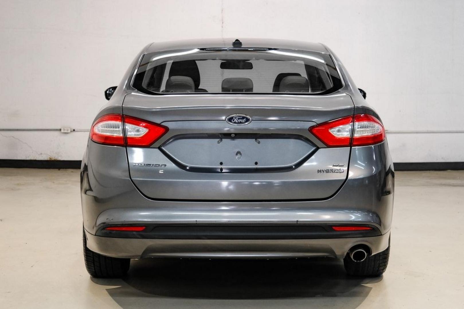 2014 Sterling Gray Metallic /Dune Ford Fusion Hybrid SE (3FA6P0LU0ER) with an 2.0L I4 Atkinson-Cycle Hybrid engine, CVT transmission, located at 15300 Midway Rd., Addison, TX, 75001, (972) 702-0011, 32.958321, -96.838074- Photo#8
