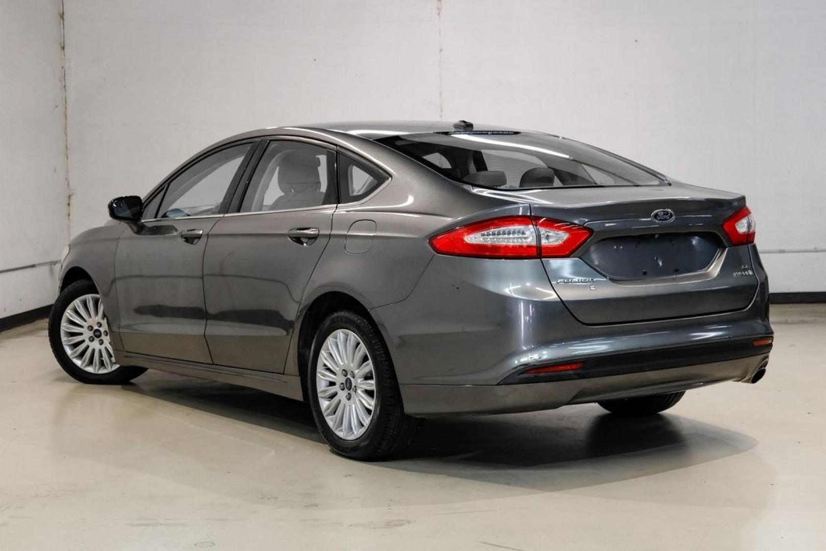 2014 Sterling Gray Metallic /Dune Ford Fusion Hybrid SE (3FA6P0LU0ER) with an 2.0L I4 Atkinson-Cycle Hybrid engine, CVT transmission, located at 15300 Midway Rd., Addison, TX, 75001, (972) 702-0011, 32.958321, -96.838074- Photo#9