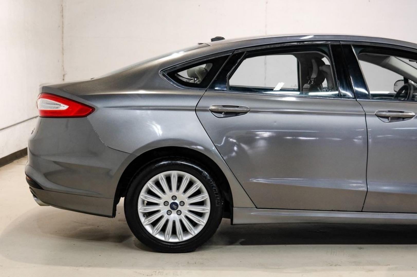 2014 Sterling Gray Metallic /Dune Ford Fusion Hybrid SE (3FA6P0LU0ER) with an 2.0L I4 Atkinson-Cycle Hybrid engine, CVT transmission, located at 15300 Midway Rd., Addison, TX, 75001, (972) 702-0011, 32.958321, -96.838074- Photo#11