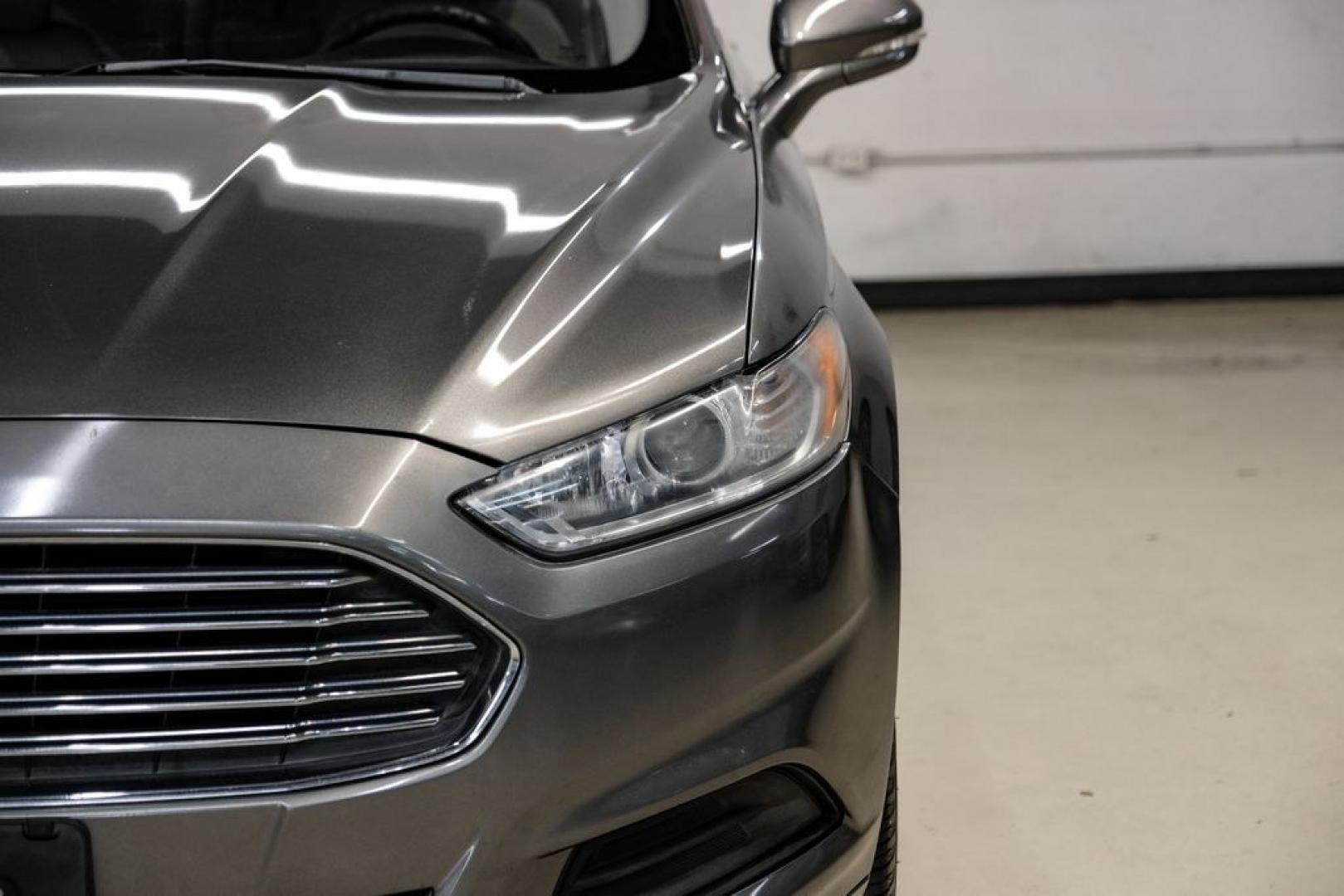 2014 Sterling Gray Metallic /Dune Ford Fusion Hybrid SE (3FA6P0LU0ER) with an 2.0L I4 Atkinson-Cycle Hybrid engine, CVT transmission, located at 15300 Midway Rd., Addison, TX, 75001, (972) 702-0011, 32.958321, -96.838074- Photo#55