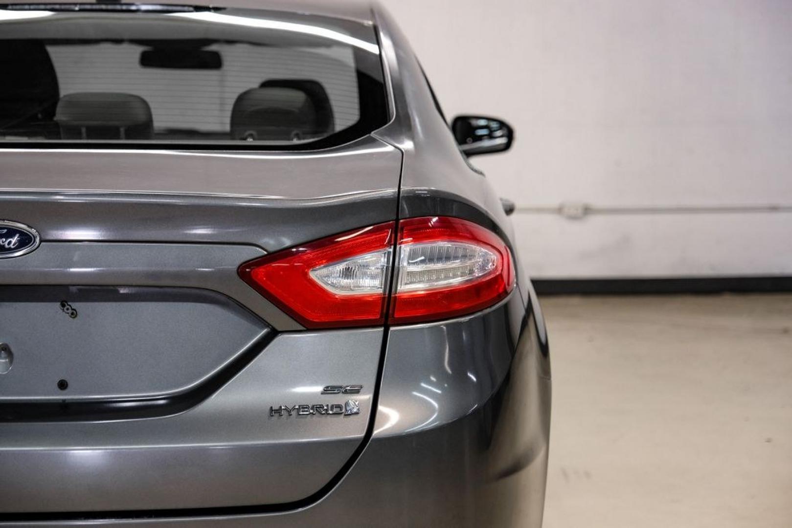 2014 Sterling Gray Metallic /Dune Ford Fusion Hybrid SE (3FA6P0LU0ER) with an 2.0L I4 Atkinson-Cycle Hybrid engine, CVT transmission, located at 15300 Midway Rd., Addison, TX, 75001, (972) 702-0011, 32.958321, -96.838074- Photo#56