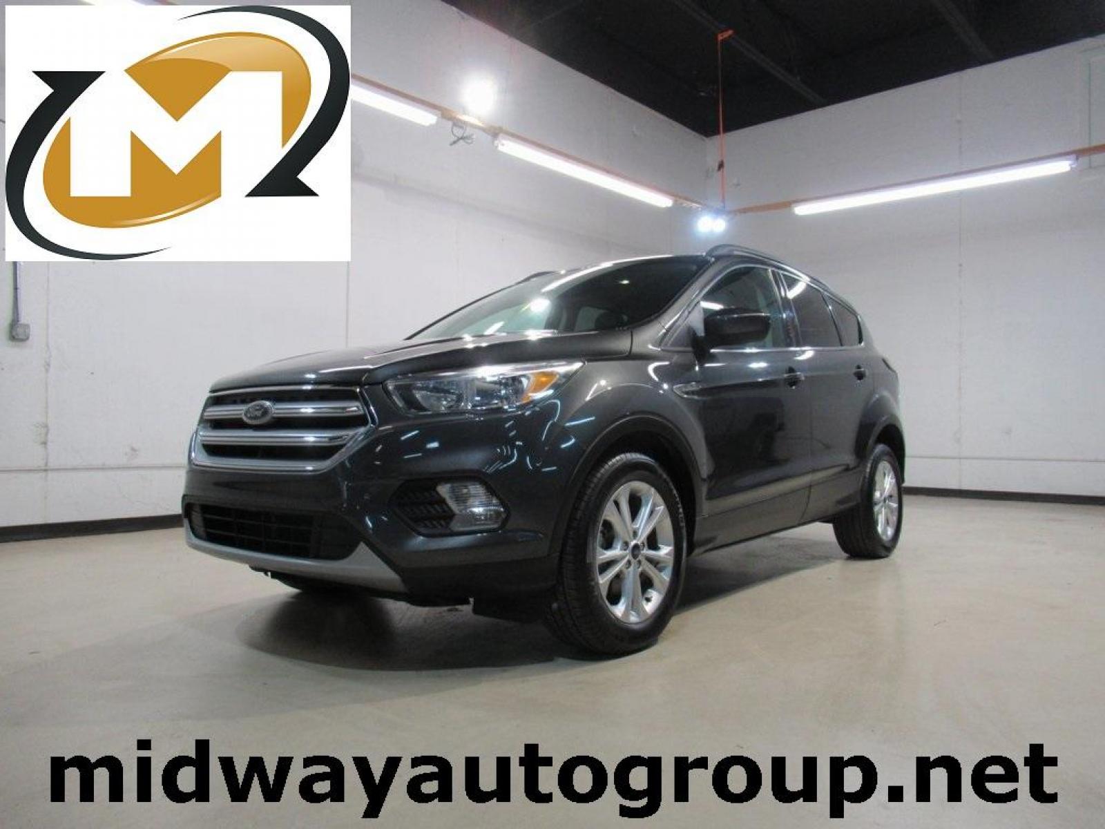 2018 Magnetic /Medium Light Stone Ford Escape SE (1FMCU0GD7JU) with an EcoBoost 1.5L I4 GTDi DOHC Turbocharged VCT engine, Automatic transmission, located at 15300 Midway Rd., Addison, 75001, (972) 702-0011, 32.958321, -96.838074 - Photo #0