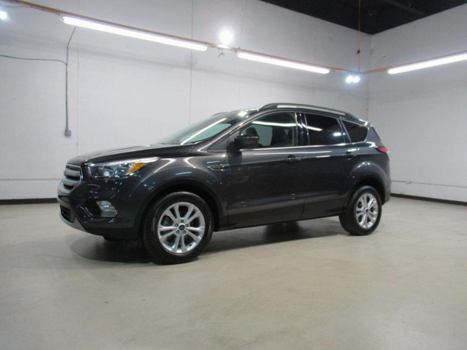 2018 Magnetic /Medium Light Stone Ford Escape SE (1FMCU0GD7JU) with an EcoBoost 1.5L I4 GTDi DOHC Turbocharged VCT engine, Automatic transmission, located at 15300 Midway Rd., Addison, 75001, (972) 702-0011, 32.958321, -96.838074 - HOME OF THE NO HAGGLE PRICE - WHOLESALE PRICES TO THE PUBLIC!! Escape SE, 4D Sport Utility, EcoBoost 1.5L I4 GTDi DOHC Turbocharged VCT, 6-Speed Automatic, FWD, Magnetic, Medium Light Stone Cloth. Odometer is 18027 miles below market average!<br><br>Magnetic 2018 Ford Escape SE<br><br>23/30 City/Hig - Photo #4