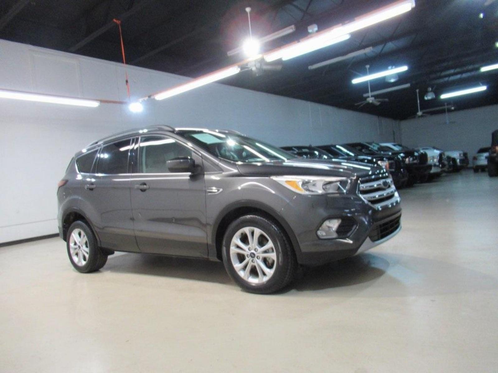 2018 Magnetic /Medium Light Stone Ford Escape SE (1FMCU0GD7JU) with an EcoBoost 1.5L I4 GTDi DOHC Turbocharged VCT engine, Automatic transmission, located at 15300 Midway Rd., Addison, 75001, (972) 702-0011, 32.958321, -96.838074 - Photo #6