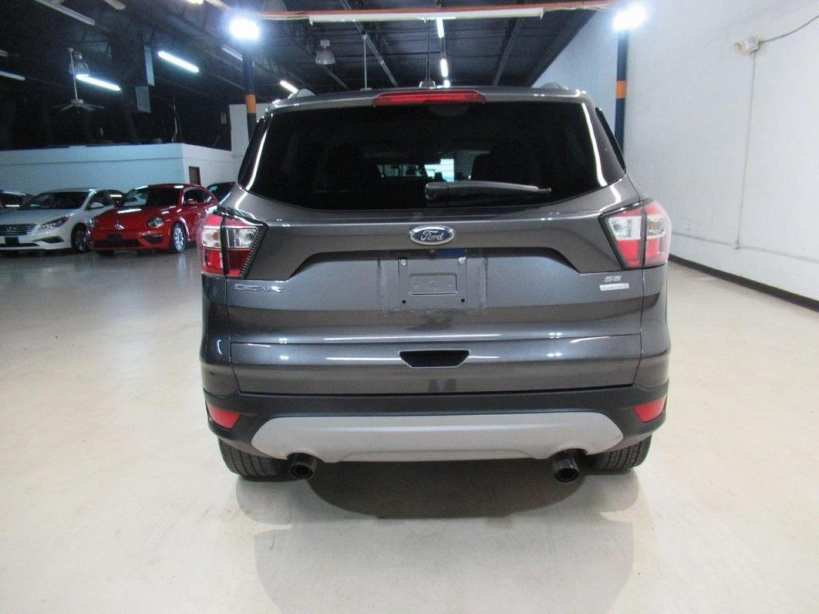 2018 Magnetic /Medium Light Stone Ford Escape SE (1FMCU0GD7JU) with an EcoBoost 1.5L I4 GTDi DOHC Turbocharged VCT engine, Automatic transmission, located at 15300 Midway Rd., Addison, 75001, (972) 702-0011, 32.958321, -96.838074 - Photo #7