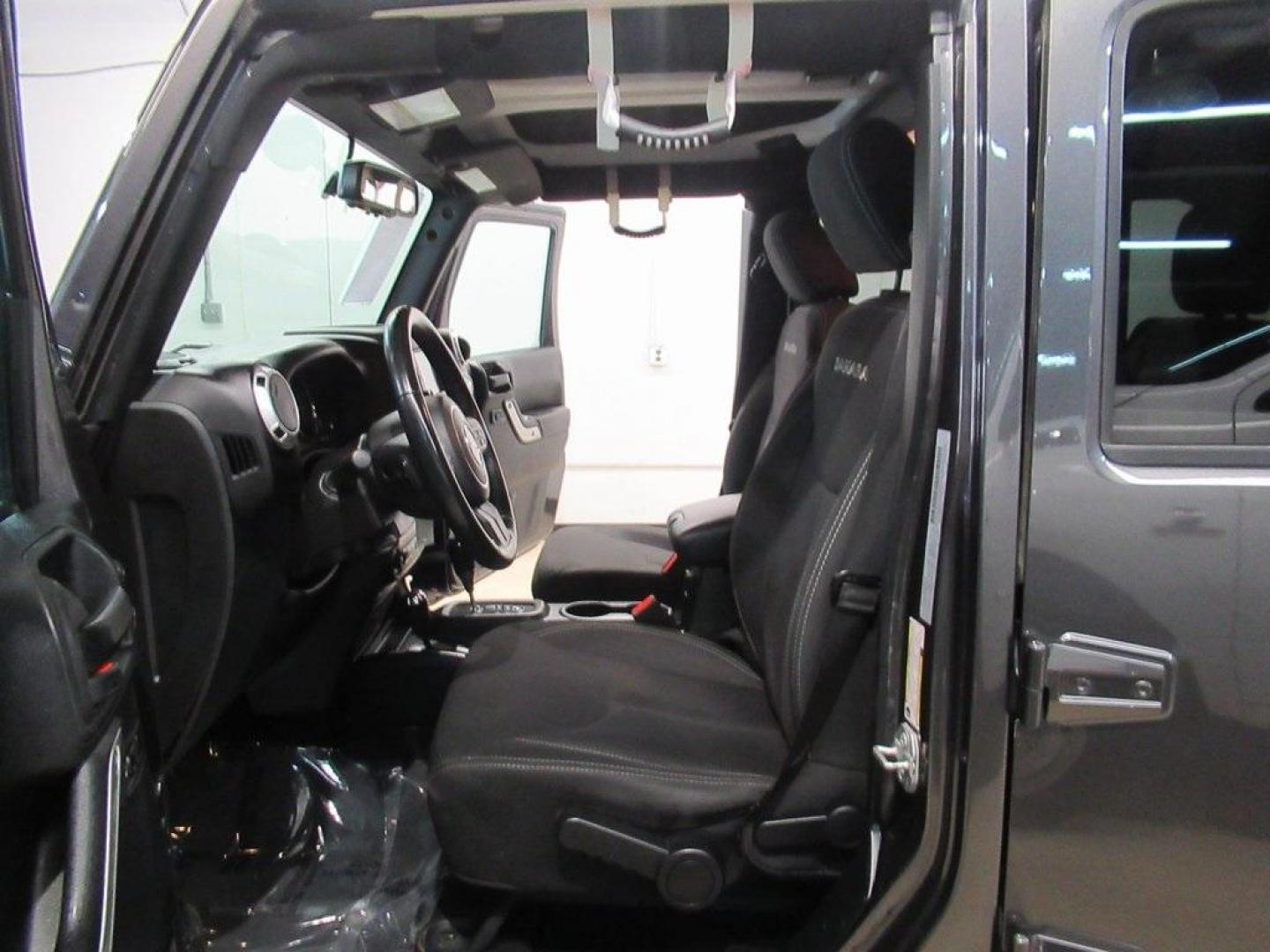 2018 Granite Crystal Metallic Clearcoat /Black Jeep Wrangler JK Unlimited Sahara (1C4BJWEG0JL) with an 3.6L V6 24V VVT engine, Automatic transmission, located at 15300 Midway Rd., Addison, TX, 75001, (972) 702-0011, 32.958321, -96.838074 - HOME OF THE NO HAGGLE PRICE - WHOLESALE PRICES TO THE PUBLIC!! Wrangler JK Unlimited Sahara, 4D Sport Utility, 3.6L V6 24V VVT, 5-Speed Automatic, 4WD, Granite Crystal Metallic Clearcoat, Black Cloth.<br><br>Granite Crystal Metallic Clearcoat 2018 Jeep Wrangler JK Unlimited Sahara<br><br>Recent Arri - Photo#12