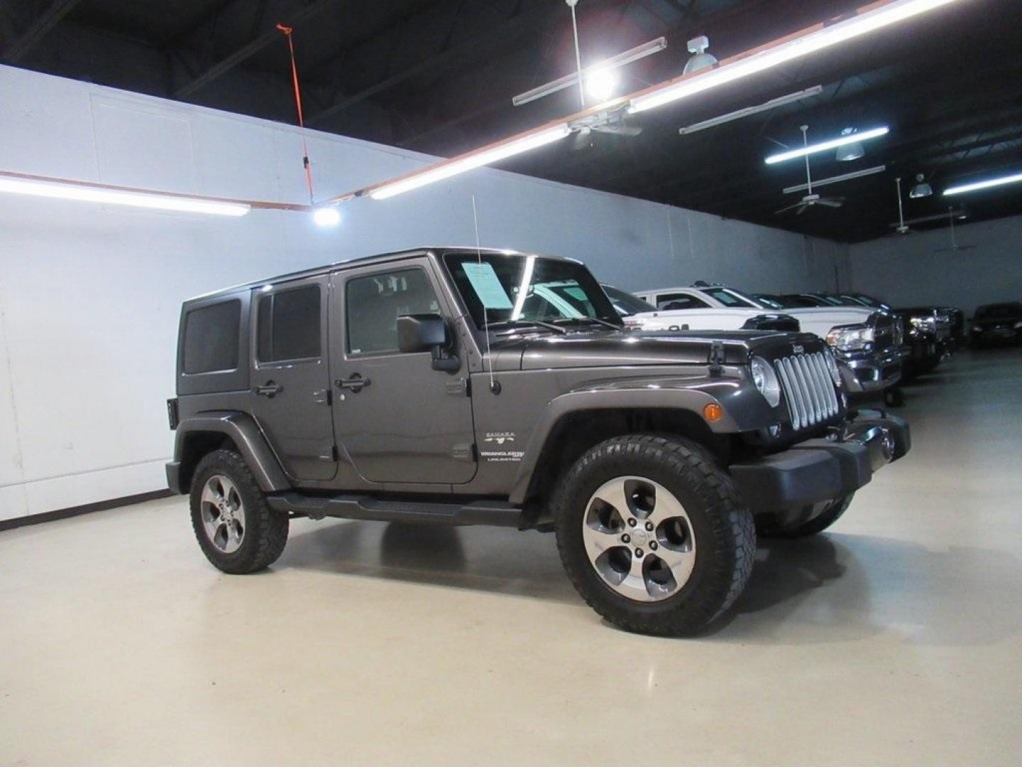 2018 Granite Crystal Metallic Clearcoat /Black Jeep Wrangler JK Unlimited Sahara (1C4BJWEG0JL) with an 3.6L V6 24V VVT engine, Automatic transmission, located at 15300 Midway Rd., Addison, TX, 75001, (972) 702-0011, 32.958321, -96.838074 - HOME OF THE NO HAGGLE PRICE - WHOLESALE PRICES TO THE PUBLIC!! Wrangler JK Unlimited Sahara, 4D Sport Utility, 3.6L V6 24V VVT, 5-Speed Automatic, 4WD, Granite Crystal Metallic Clearcoat, Black Cloth.<br><br>Granite Crystal Metallic Clearcoat 2018 Jeep Wrangler JK Unlimited Sahara<br><br>Recent Arri - Photo#5