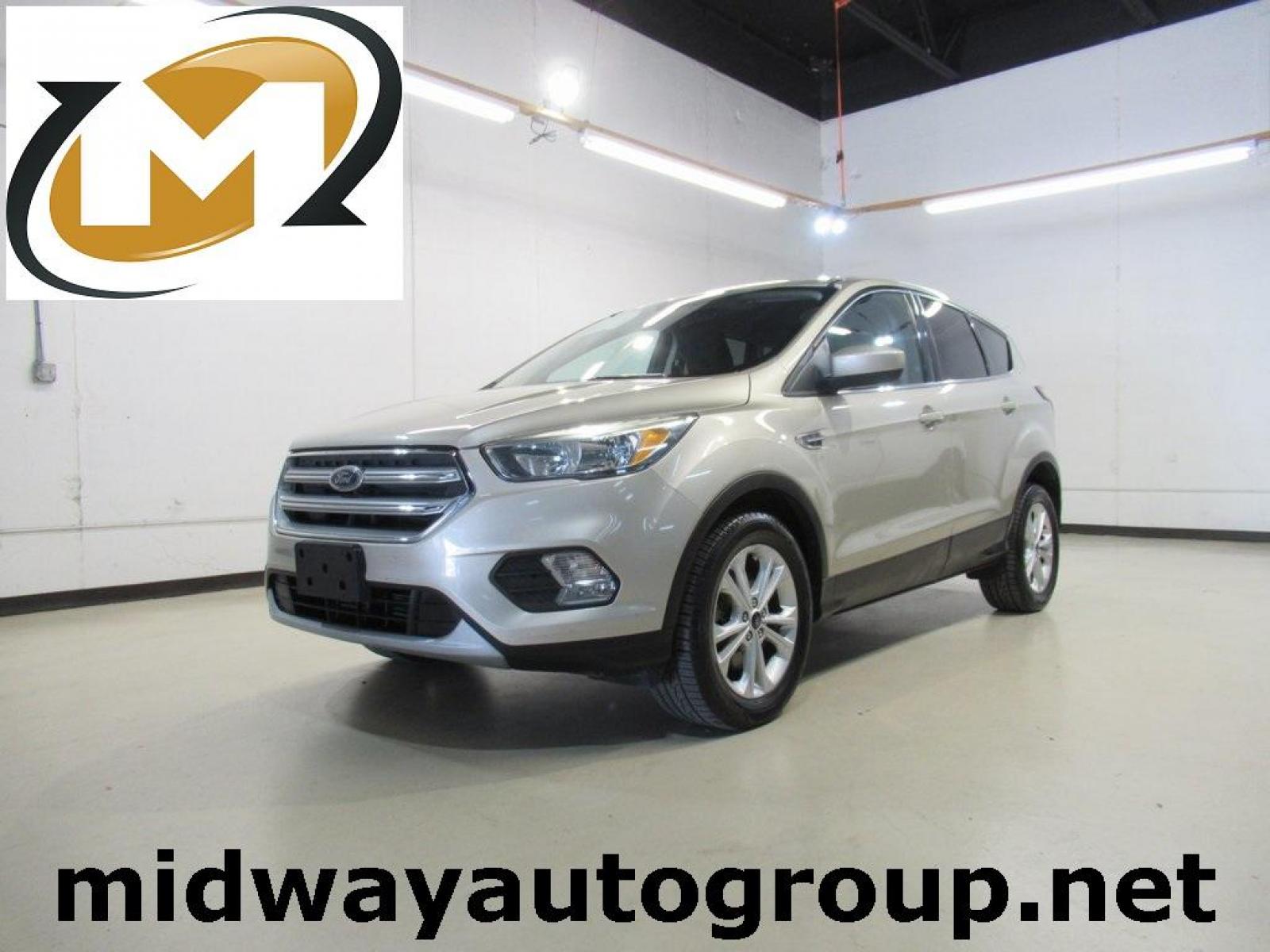 2017 White Gold Metallic /Charcoal Black Ford Escape SE (1FMCU0G94HU) with an EcoBoost 2.0L I4 GTDi DOHC Turbocharged VCT engine, Automatic transmission, located at 15300 Midway Rd., Addison, 75001, (972) 702-0011, 32.958321, -96.838074 - HOME OF THE NO HAGGLE PRICE - WHOLESALE PRICES TO THE PUBLIC!! Escape SE, 4D Sport Utility, EcoBoost 2.0L I4 GTDi DOHC Turbocharged VCT, 6-Speed Automatic, FWD, Gold, Charcoal Black Cloth.<br><br>Gold 2017 Ford Escape SE<br><br>Recent Arrival! 22/29 City/Highway MPG<br><br>Awards:<br> * 2017 KBB.co - Photo #0