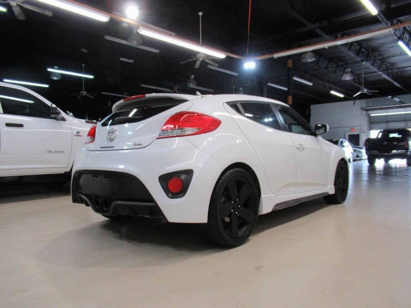 2014 Elite White Pearl /Black Hyundai Veloster Base (KMHTC6AE8EU) with an 1.6L I4 engine, Automatic transmission, located at 15300 Midway Rd., Addison, 75001, (972) 702-0011, 32.958321, -96.838074 - HOME OF THE NO HAGGLE PRICE - WHOLESALE PRICES TO THE PUBLIC!! 3D Hatchback, 1.6L I4, 6-Speed, FWD, White. Odometer is 2034 miles below market average!<br><br>White 2014 Hyundai Veloster<br><br>Recent Arrival!<br><br>Awards:<br> * 2014 KBB.com 10 Coolest New Cars Under $18,000<br><br>At Midway Auto - Photo #2