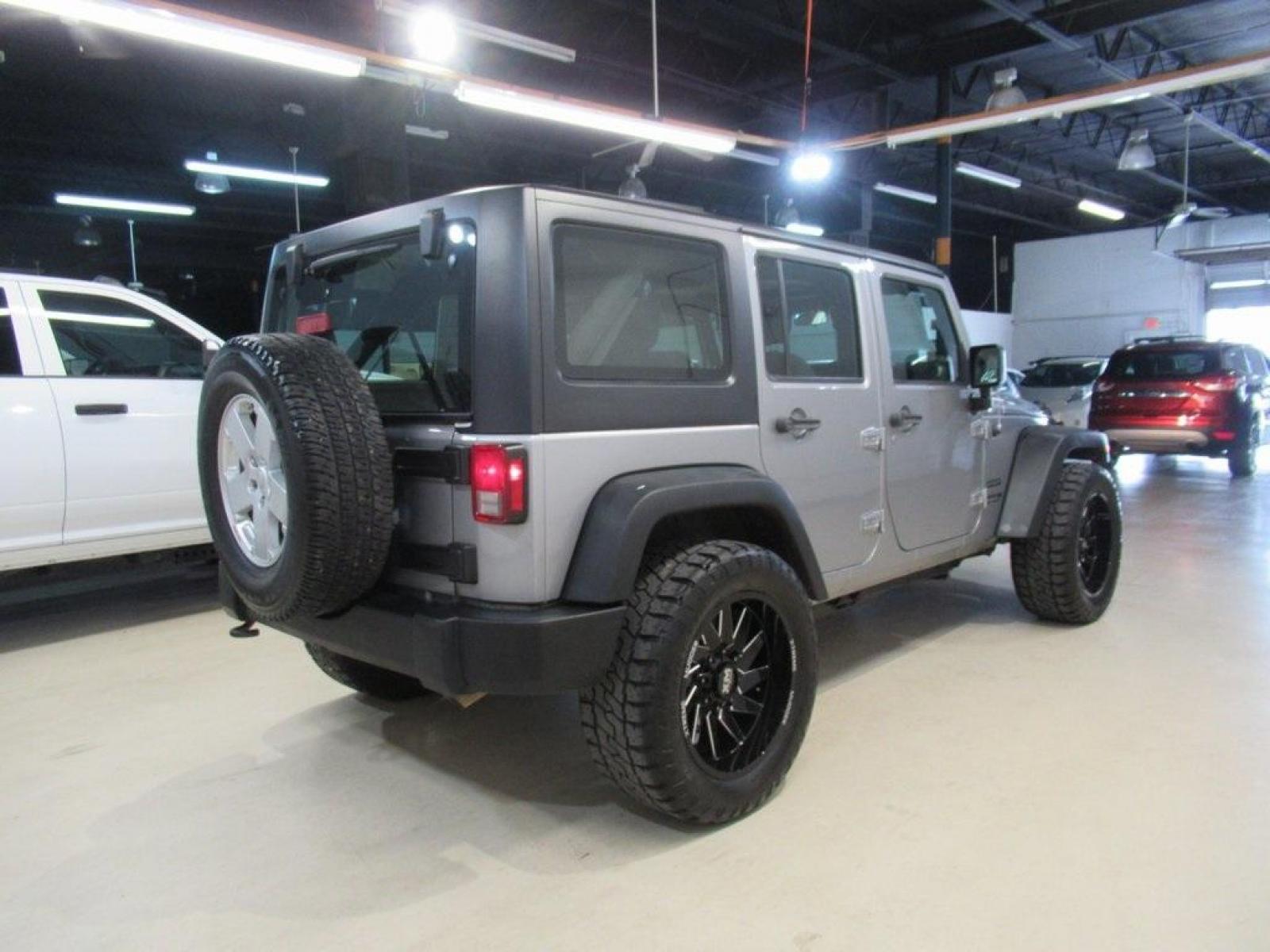 2018 Billet Silver Metallic Clearcoat /Black Jeep Wrangler JK Unlimited Sport (1C4BJWDG6JL) with an 3.6L V6 24V VVT engine, Automatic transmission, located at 15300 Midway Rd., Addison, 75001, (972) 702-0011, 32.958321, -96.838074 - HOME OF THE NO HAGGLE PRICE - WHOLESALE PRICES TO THE PUBLIC!! 4D Sport Utility, 3.6L V6 24V VVT, 4WD, Silver, ABS brakes, Compass, Electronic Stability Control, Low tire pressure warning, Traction control.<br><br>Silver 2018 Jeep Wrangler JK Unlimited Sport<br><br>Recent Arrival!<br><br>Awards:<br> - Photo #2
