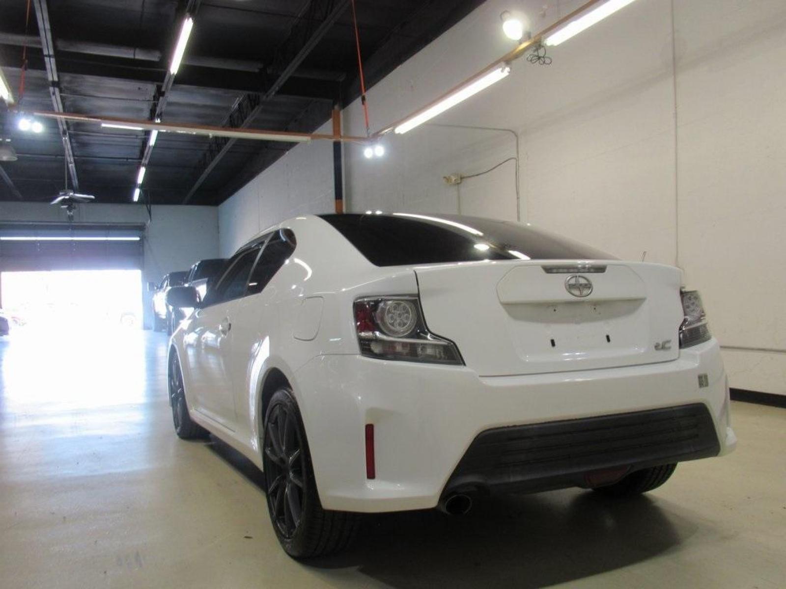 2014 Super White /Dark Charcoal Scion tC Base (JTKJF5C73E3) with an 2.5L I4 Dual VVT-i engine, Automatic transmission, located at 15300 Midway Rd., Addison, 75001, (972) 702-0011, 32.958321, -96.838074 - HOME OF THE NO HAGGLE PRICE - WHOLESALE PRICES TO THE PUBLIC!! 2D Coupe, 2.5L I4 Dual VVT-i, 6-Speed Automatic, FWD, Super White.<br><br>Super White 2014 Scion tC<br><br>23/31 City/Highway MPG<br><br>Awards:<br> * 2014 IIHS Top Safety Pick, Top Safety Pick, Top Safety Pick+<br><br>At Midway Auto Gr - Photo #1