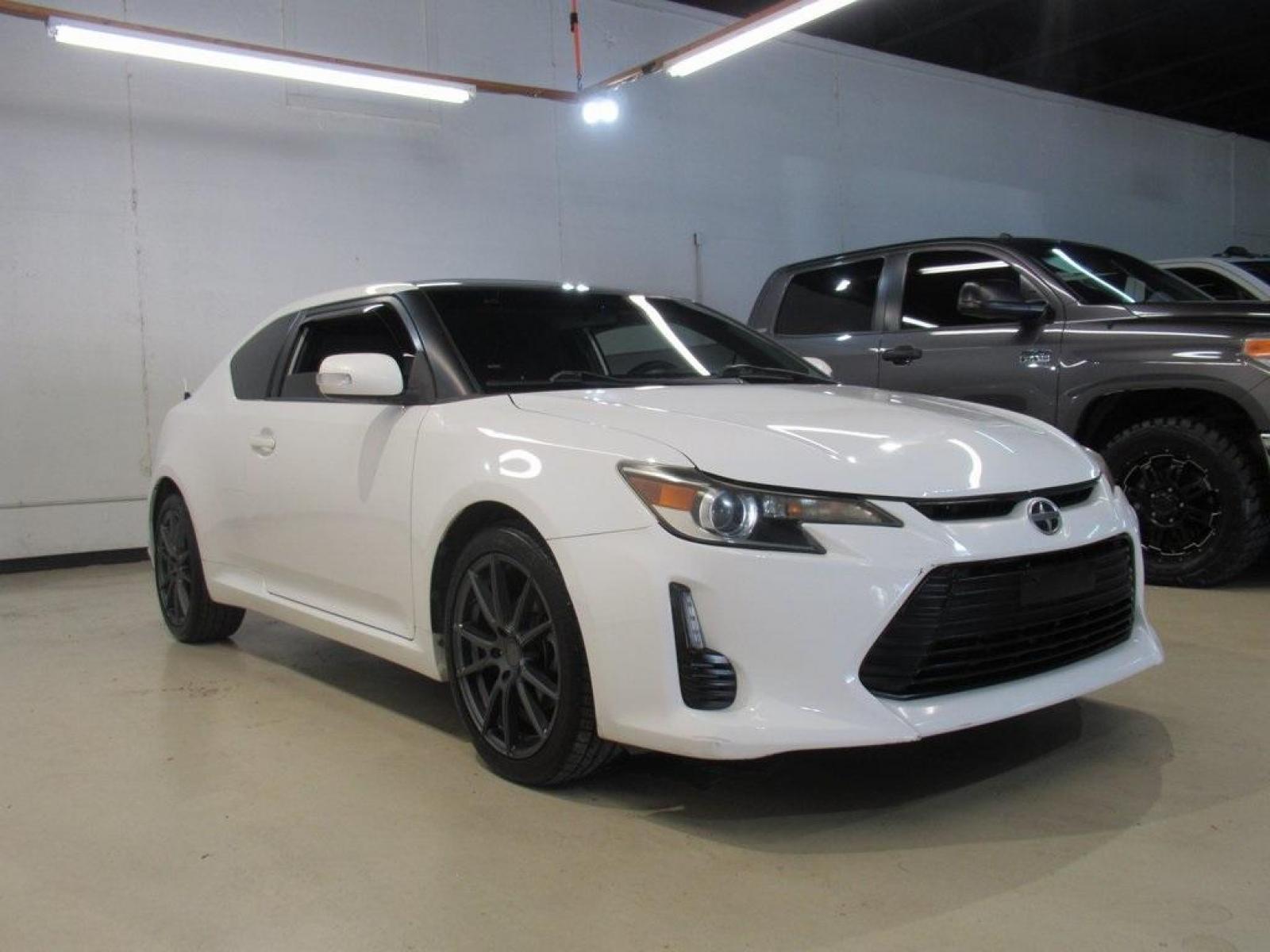2014 Super White /Dark Charcoal Scion tC Base (JTKJF5C73E3) with an 2.5L I4 Dual VVT-i engine, Automatic transmission, located at 15300 Midway Rd., Addison, 75001, (972) 702-0011, 32.958321, -96.838074 - HOME OF THE NO HAGGLE PRICE - WHOLESALE PRICES TO THE PUBLIC!! 2D Coupe, 2.5L I4 Dual VVT-i, 6-Speed Automatic, FWD, Super White.<br><br>Super White 2014 Scion tC<br><br>23/31 City/Highway MPG<br><br>Awards:<br> * 2014 IIHS Top Safety Pick, Top Safety Pick, Top Safety Pick+<br><br>At Midway Auto Gr - Photo #3