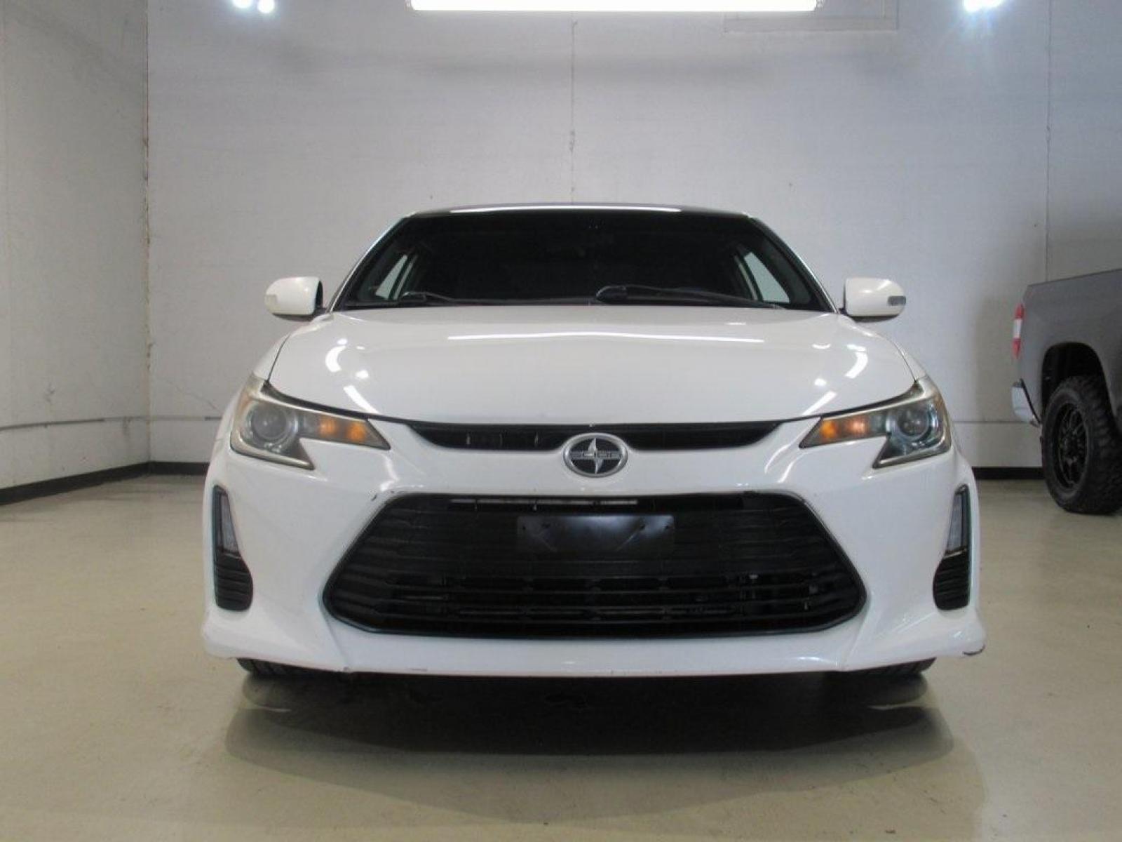 2014 Super White /Dark Charcoal Scion tC Base (JTKJF5C73E3) with an 2.5L I4 Dual VVT-i engine, Automatic transmission, located at 15300 Midway Rd., Addison, 75001, (972) 702-0011, 32.958321, -96.838074 - HOME OF THE NO HAGGLE PRICE - WHOLESALE PRICES TO THE PUBLIC!! 2D Coupe, 2.5L I4 Dual VVT-i, 6-Speed Automatic, FWD, Super White.<br><br>Super White 2014 Scion tC<br><br>23/31 City/Highway MPG<br><br>Awards:<br> * 2014 IIHS Top Safety Pick, Top Safety Pick, Top Safety Pick+<br><br>At Midway Auto Gr - Photo #4