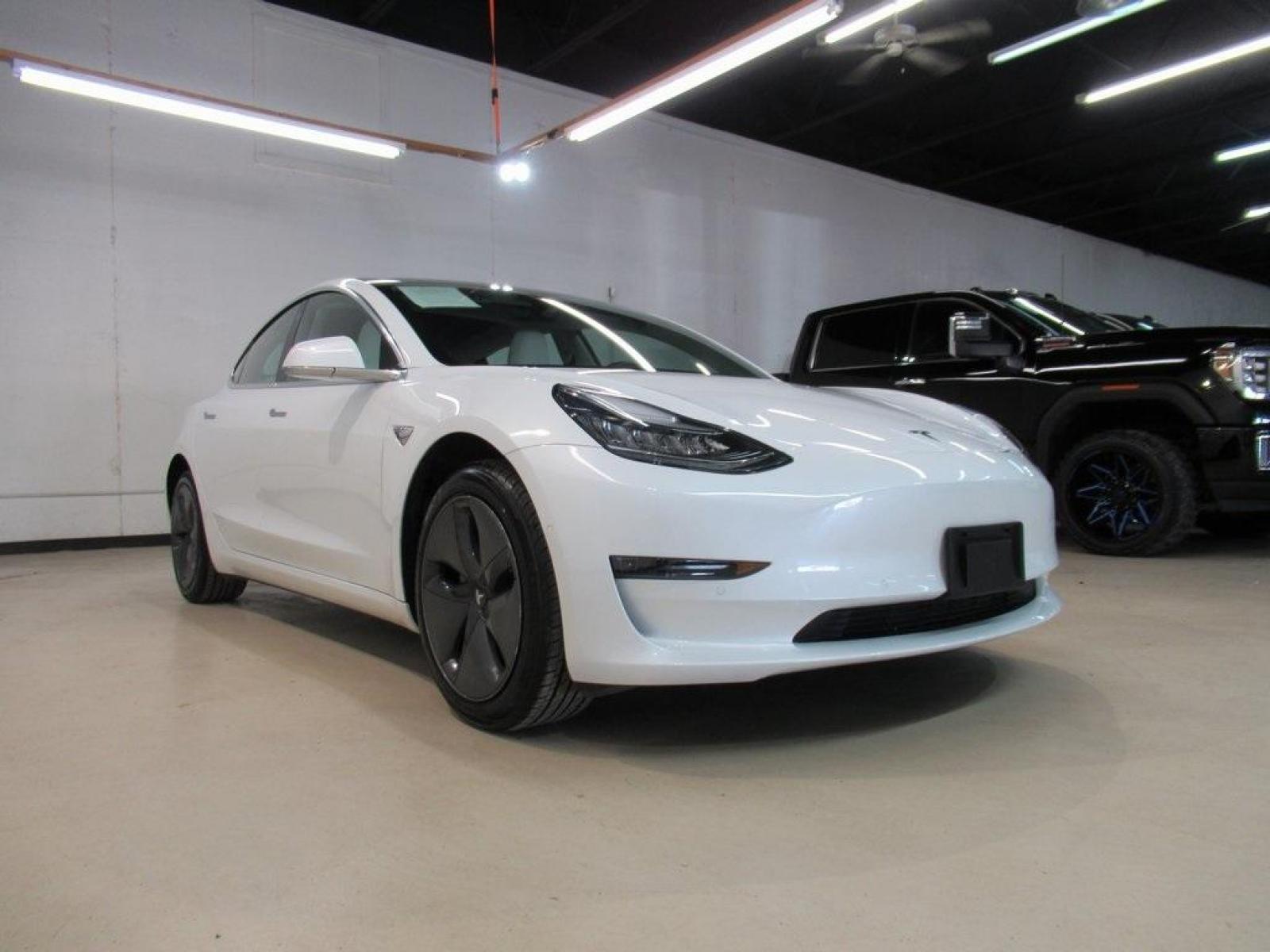 2019 Pearl White Multi-Coat /White/Black Tesla Model 3 Mid Range (5YJ3E1EA3KF) with an 10-Cylinder Electric ZEV engine, Automatic transmission, located at 15300 Midway Rd., Addison, 75001, (972) 702-0011, 32.958321, -96.838074 - HOME OF THE NO HAGGLE PRICE - WHOLESALE PRICES TO THE PUBLIC!! Model 3 Mid Range, 4D Sedan, 10-Cylinder Electric ZEV, 1-Speed Automatic, RWD, White, White/Black w/Premium Seat Trim. Priced below KBB Fair Purchase Price! Odometer is 6764 miles below market average!<br><br>White 2019 Tesla Model 3 Mid - Photo #1