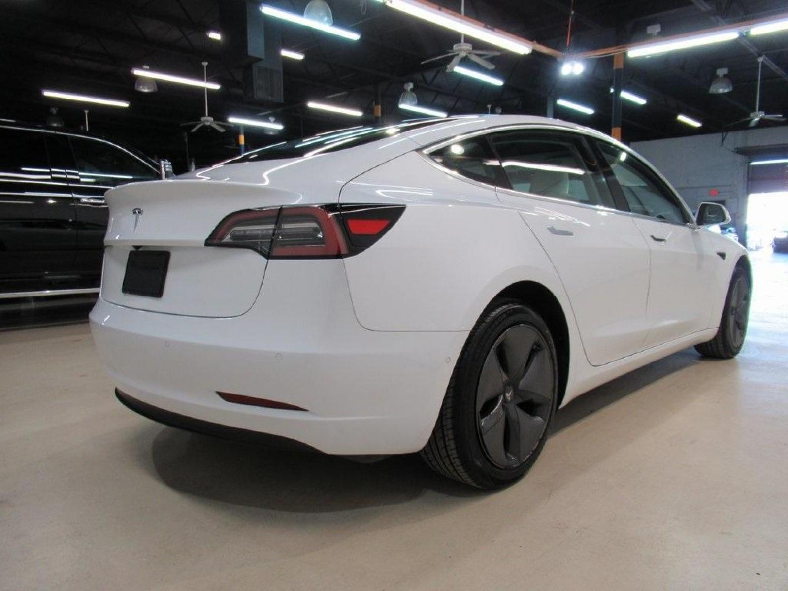 2019 Pearl White Multi-Coat /White/Black Tesla Model 3 Mid Range (5YJ3E1EA3KF) with an 10-Cylinder Electric ZEV engine, Automatic transmission, located at 15300 Midway Rd., Addison, 75001, (972) 702-0011, 32.958321, -96.838074 - HOME OF THE NO HAGGLE PRICE - WHOLESALE PRICES TO THE PUBLIC!! Model 3 Mid Range, 4D Sedan, 10-Cylinder Electric ZEV, 1-Speed Automatic, RWD, White, White/Black w/Premium Seat Trim. Priced below KBB Fair Purchase Price! Odometer is 6764 miles below market average!<br><br>White 2019 Tesla Model 3 Mid - Photo #2