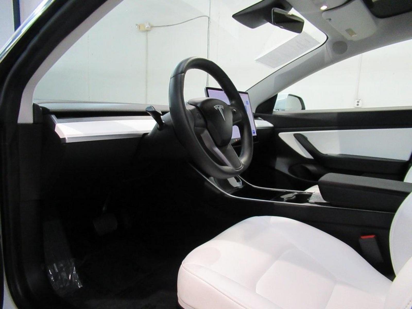 2019 Pearl White Multi-Coat /White/Black Tesla Model 3 Mid Range (5YJ3E1EA3KF) with an 10-Cylinder Electric ZEV engine, Automatic transmission, located at 15300 Midway Rd., Addison, 75001, (972) 702-0011, 32.958321, -96.838074 - HOME OF THE NO HAGGLE PRICE - WHOLESALE PRICES TO THE PUBLIC!! Model 3 Mid Range, 4D Sedan, 10-Cylinder Electric ZEV, 1-Speed Automatic, RWD, White, White/Black w/Premium Seat Trim. Priced below KBB Fair Purchase Price! Odometer is 6764 miles below market average!<br><br>White 2019 Tesla Model 3 Mid - Photo #32